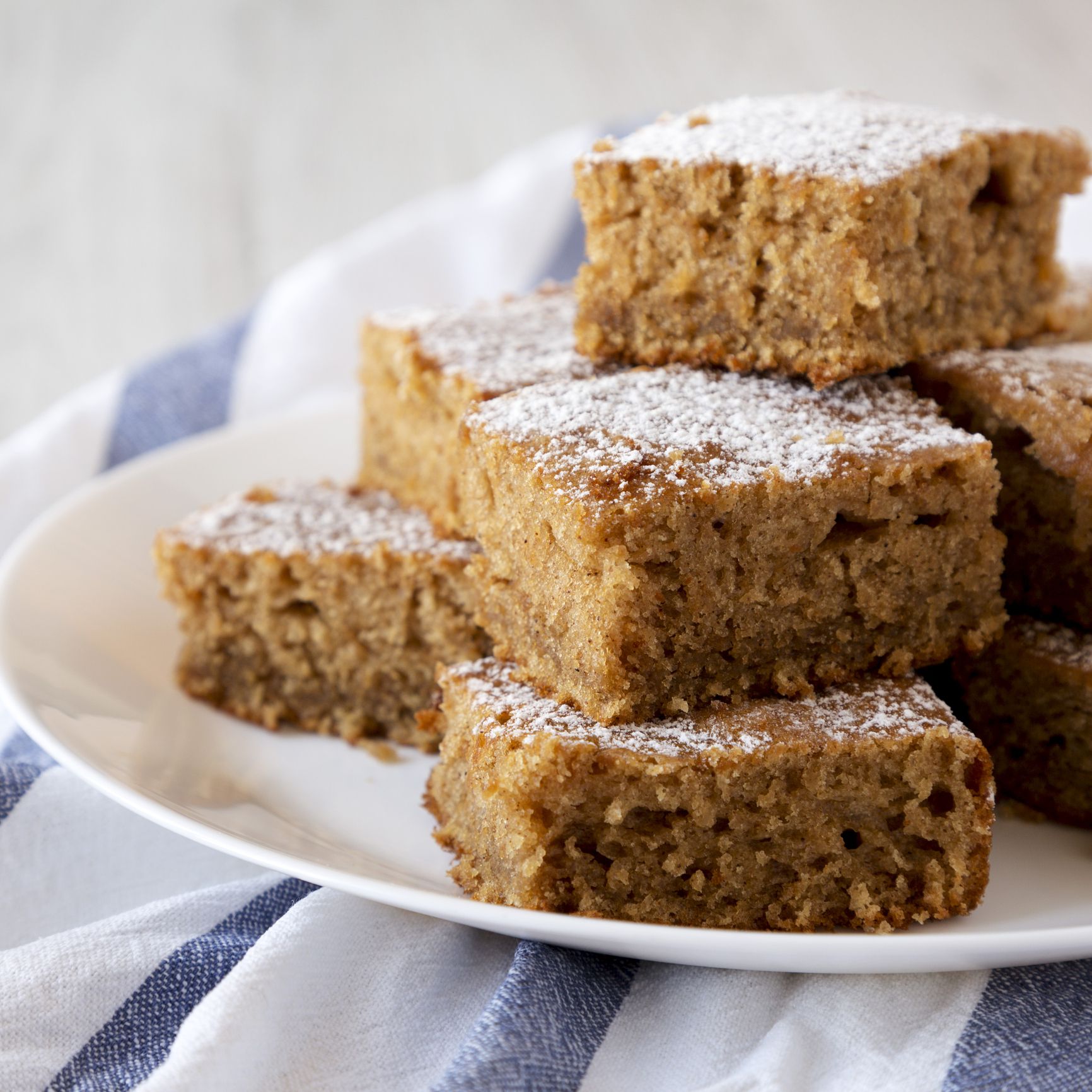 Homemade Tasty Applesauce Cake on a white plate, low angle view. Close-up.