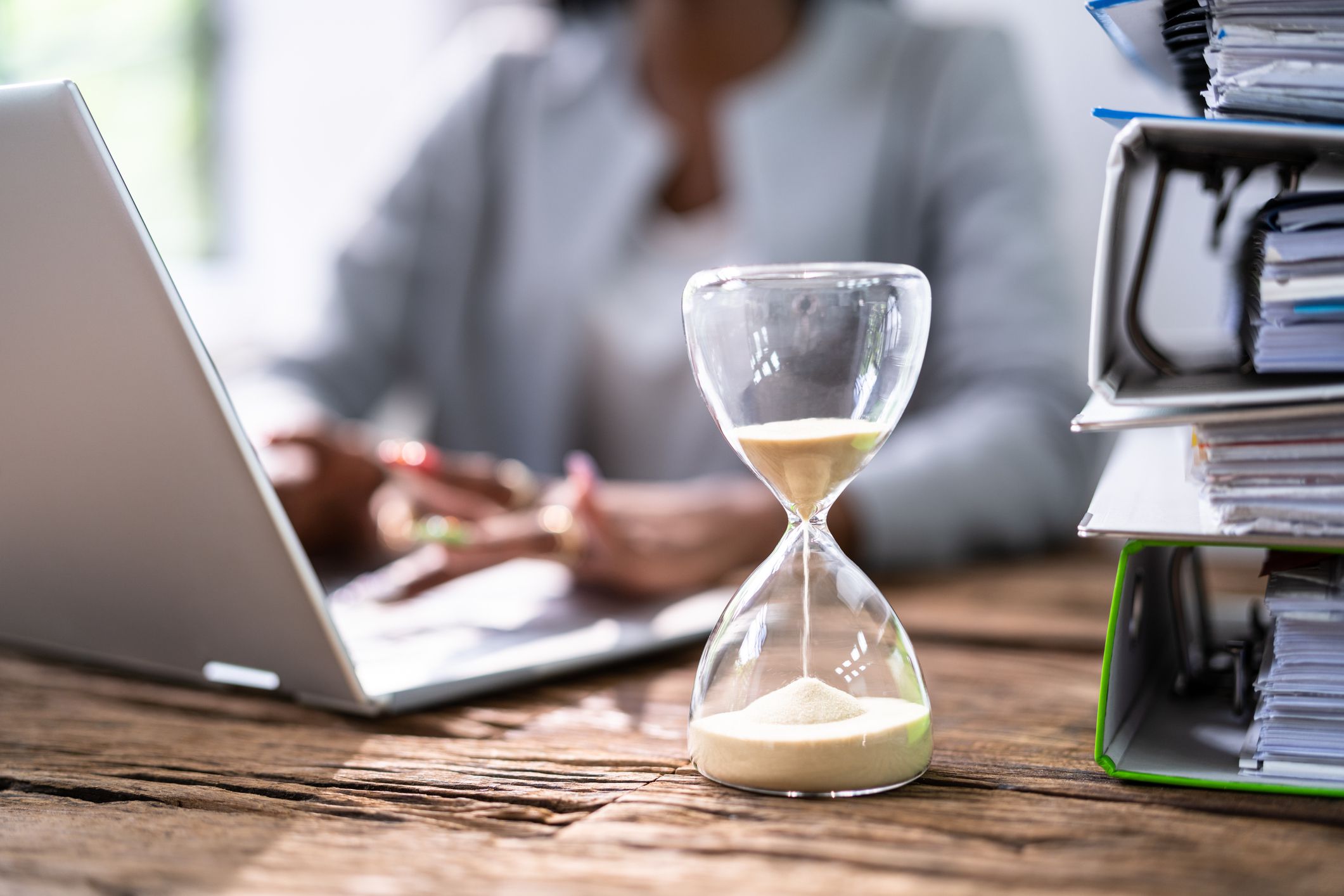 Black Accountant Woman Working With Invoice And Hourglass