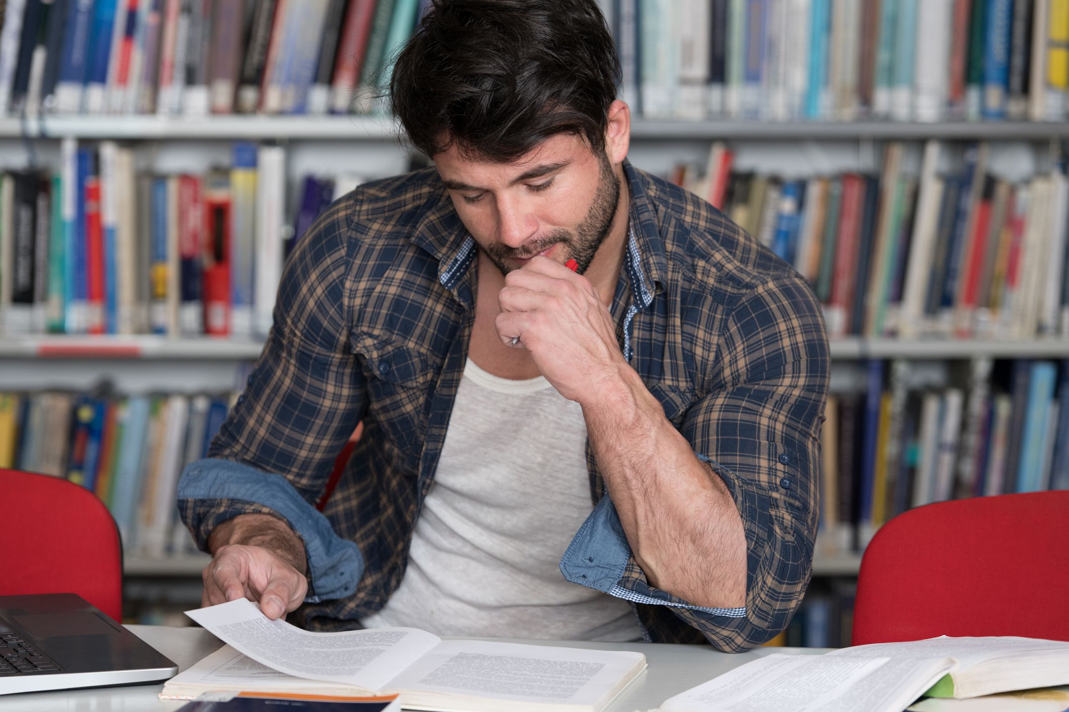 Portrait of an Attractive Student Doing Some School Work With a Laptop in the Library