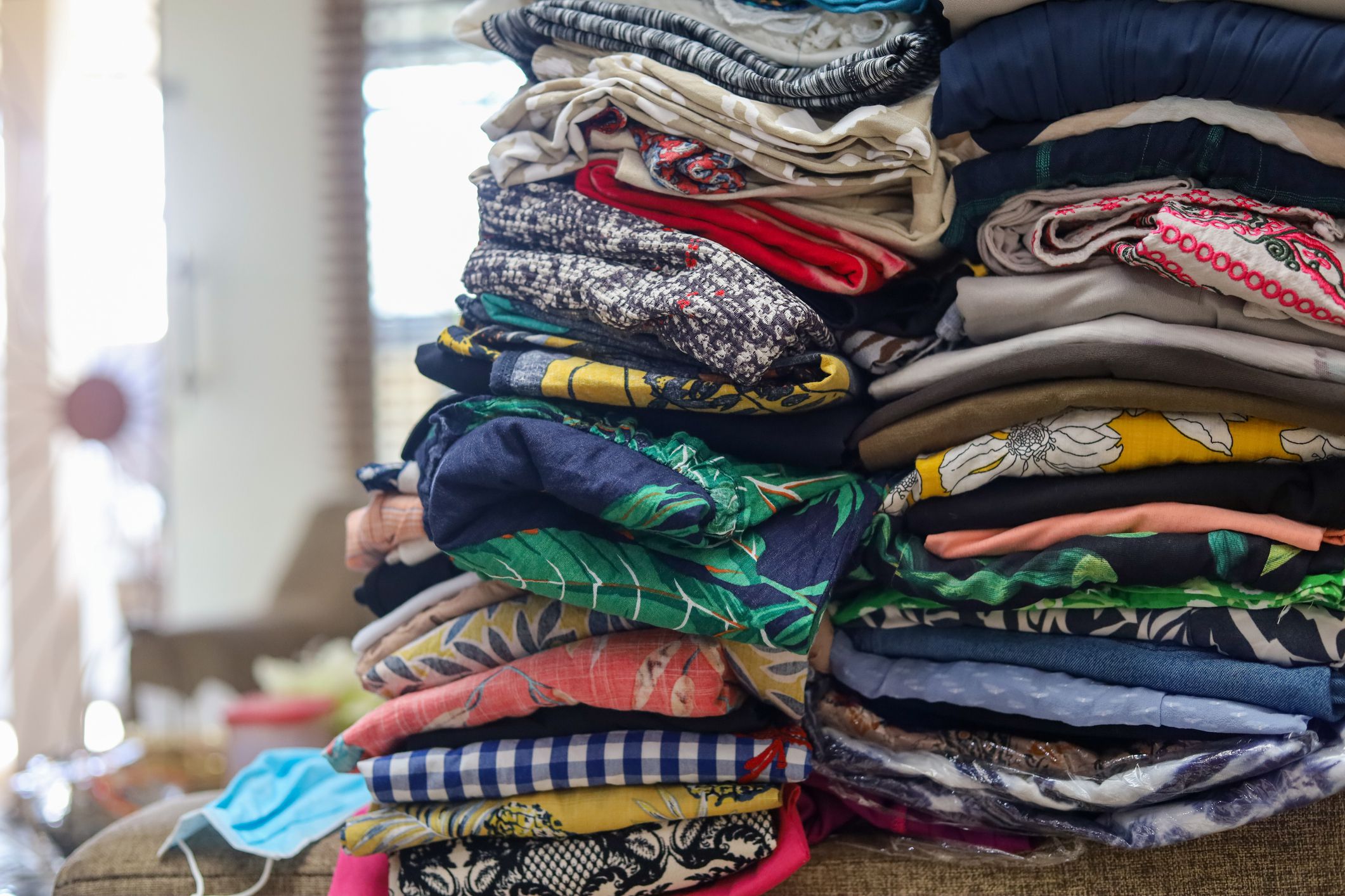 piles of used clothes to be sold in the used clothing market