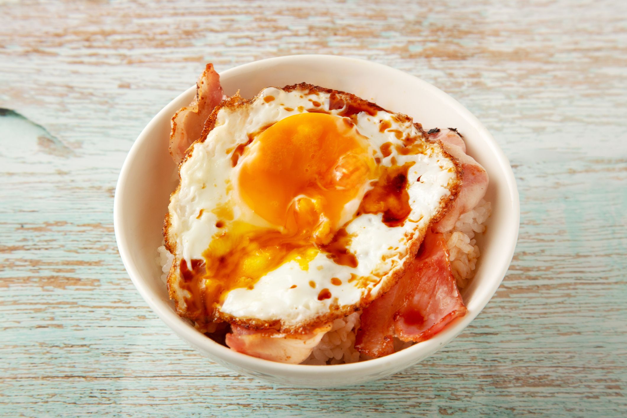Beacon and fried egg on top of rice