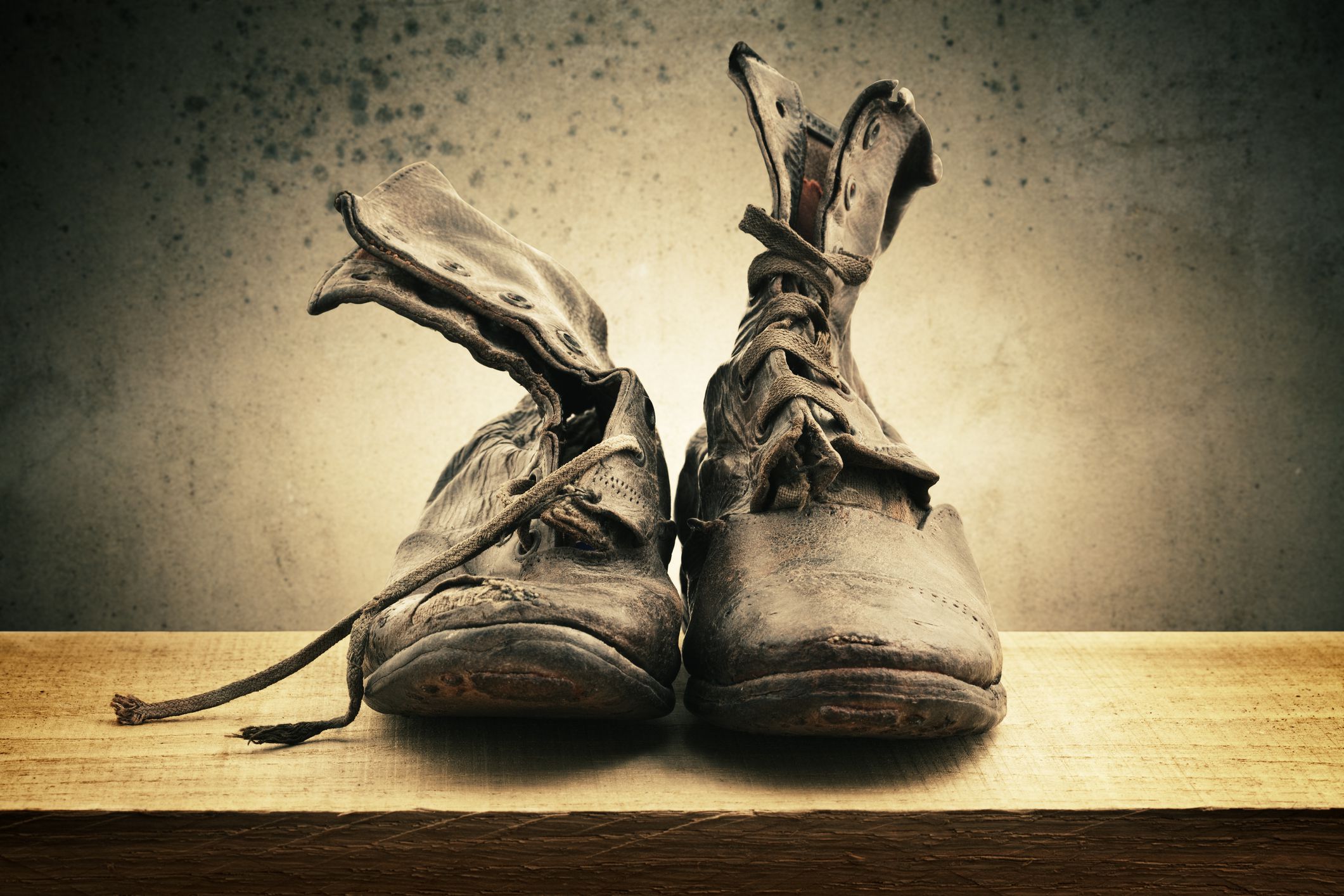 A studio shot of a pair of old boots. This image is unsharpened and cross-processed.