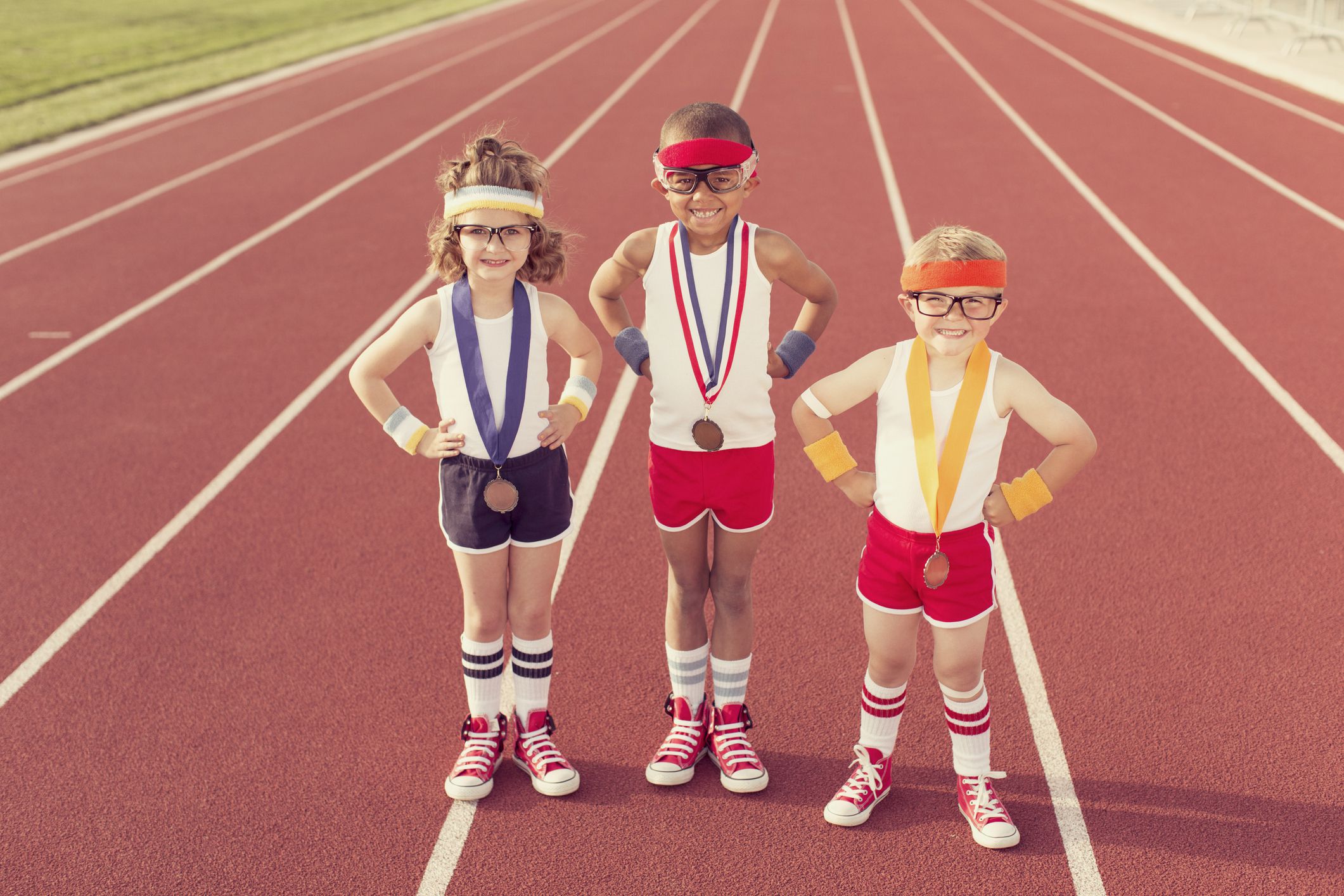 Three little track champions show off their medals.