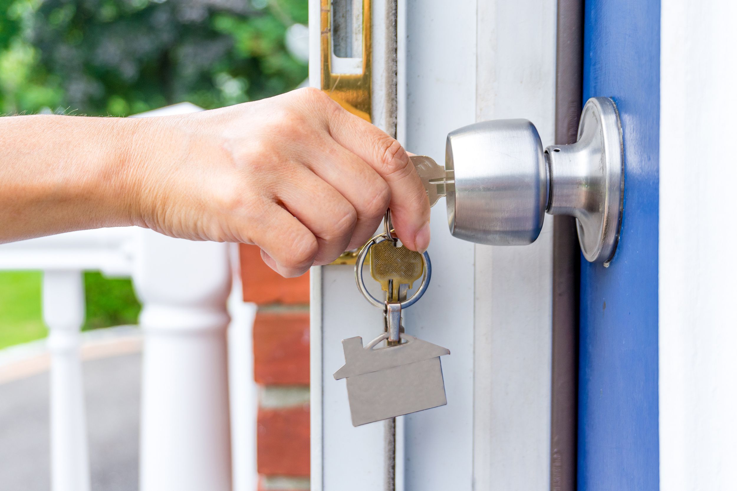 hand opening a door with keys