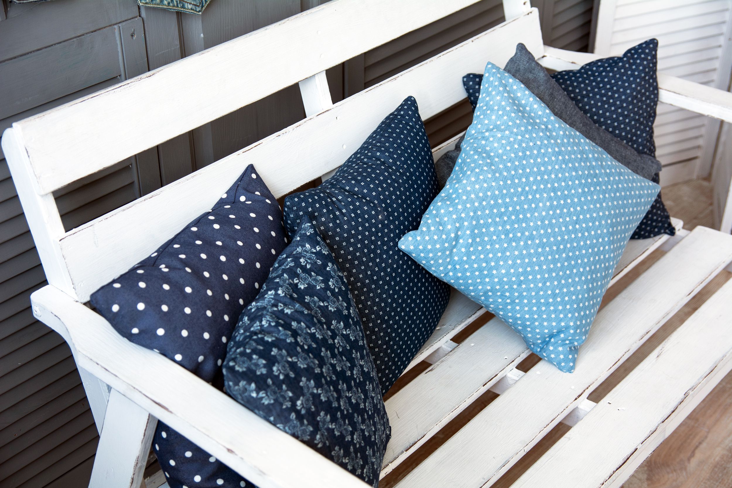 wooden white bench with pillows