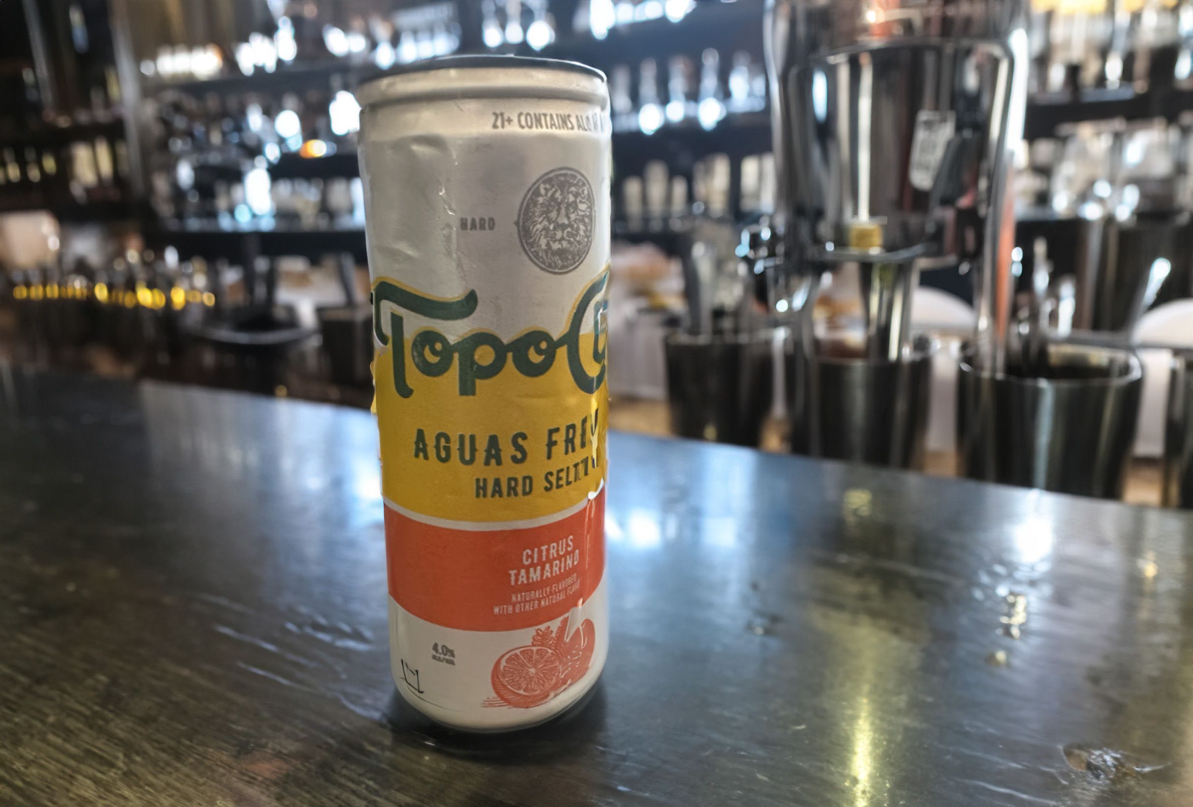 Citrus Tamarind Topo Chico Hard Seltzer can on a bar