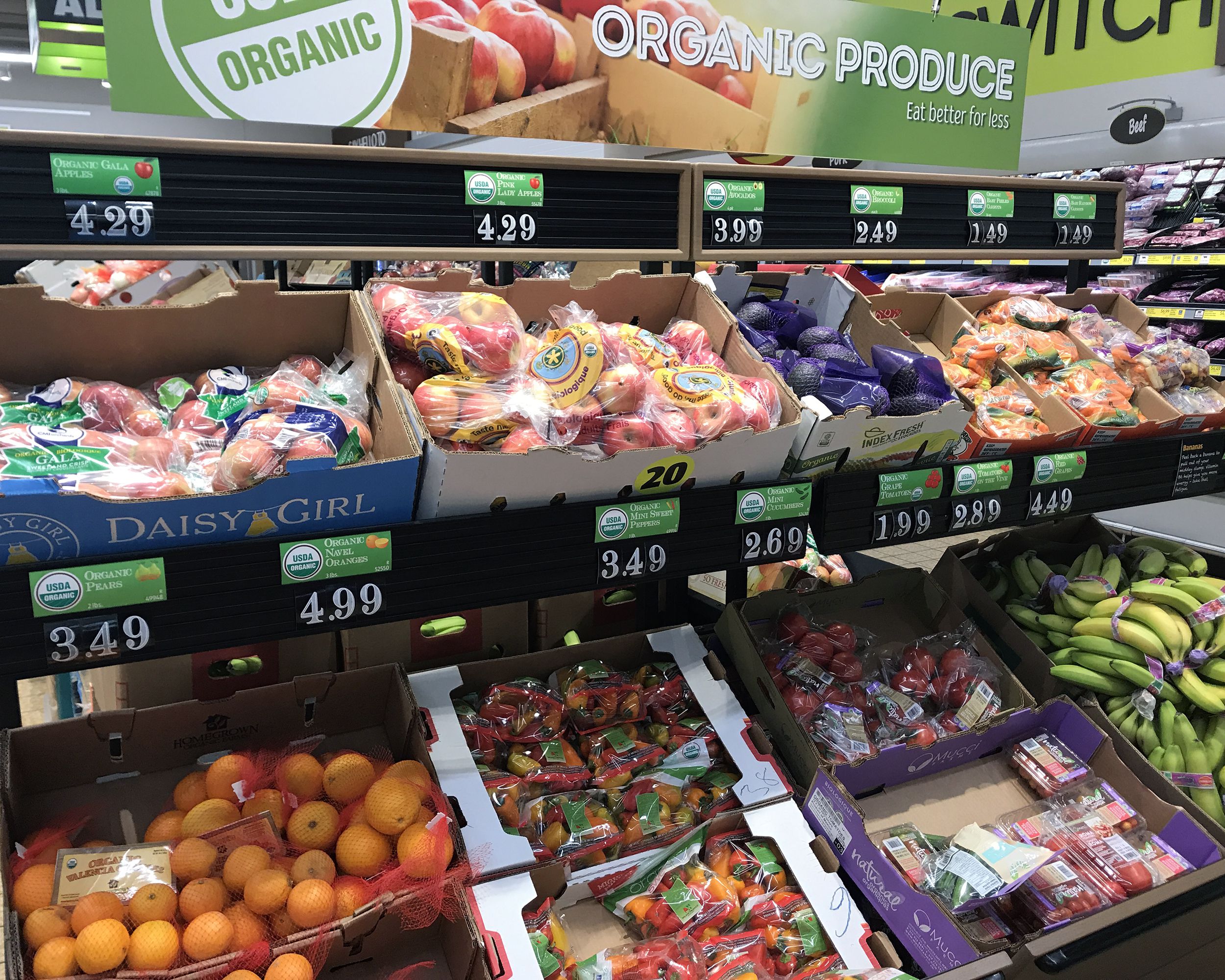 Closeup of organic produce area of an Aldi store, several organic fruits and vegetables on display of 2 rows