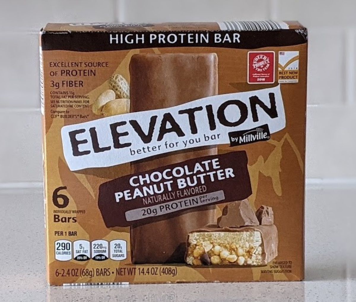 Elevation by Millville, Chocolate Peanut Butter, on a light grey countertop with light grey tiles in the background