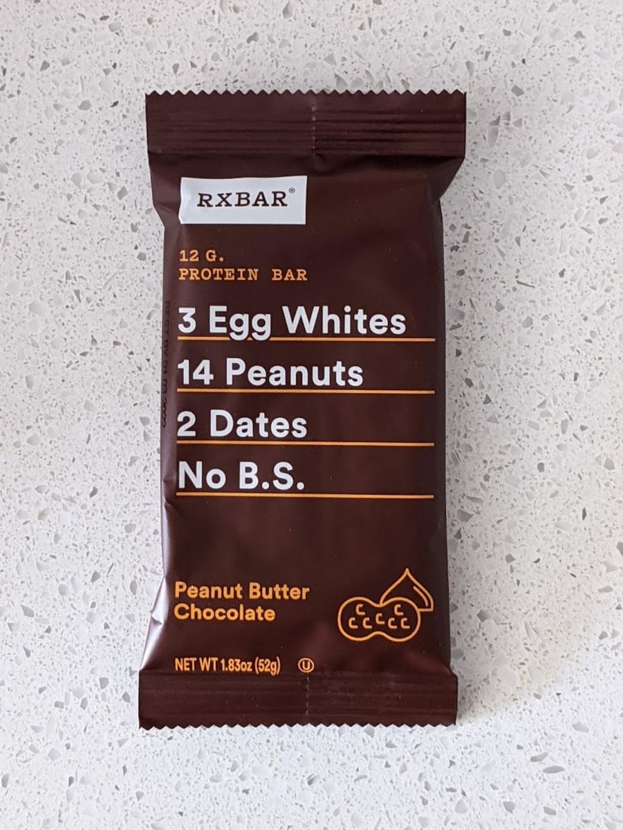 RXBar, Peanut Butter Chocolate, on a light grey countertop with light grey tiles in the background