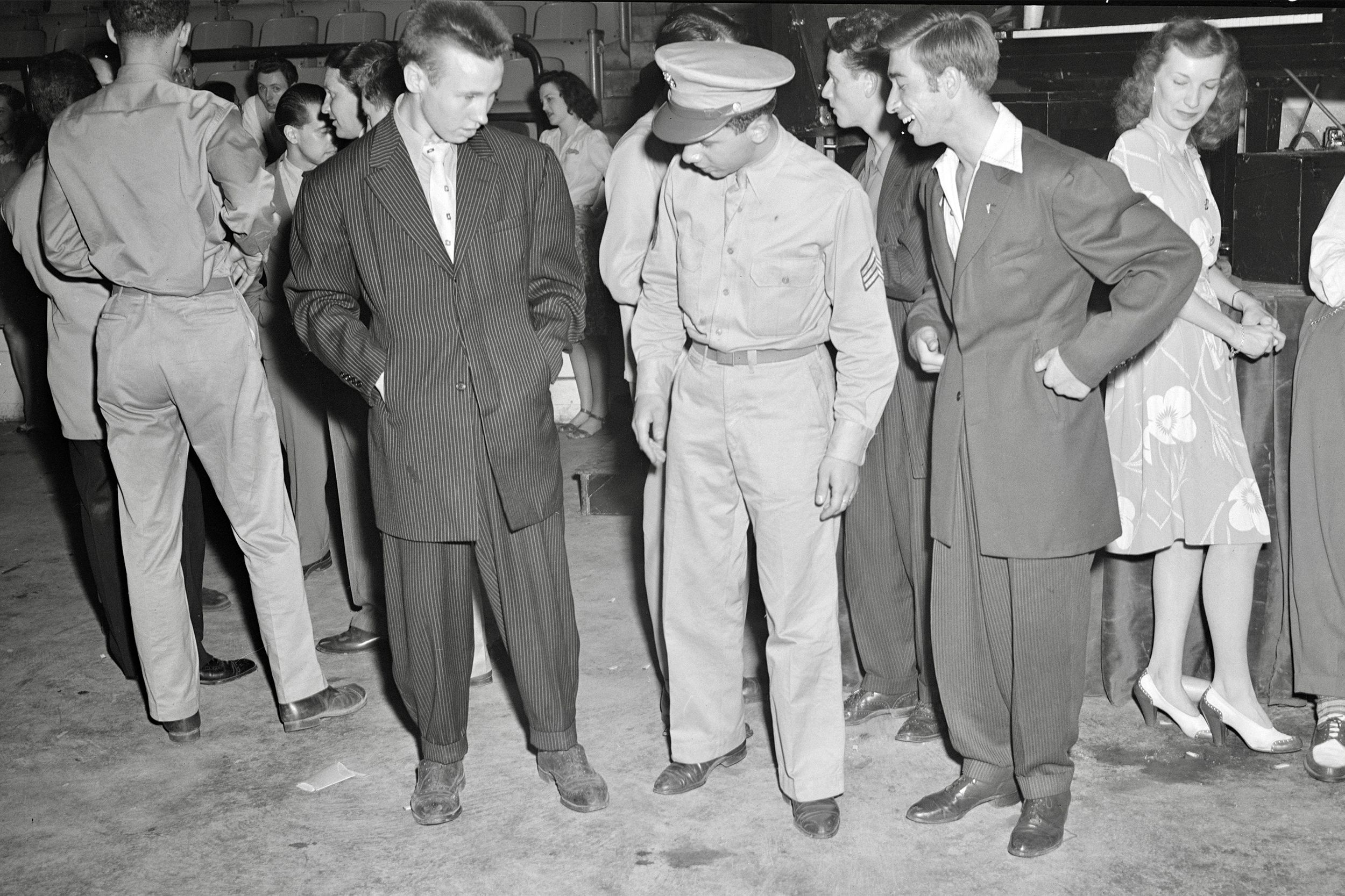 A soldier with two men wearing zoot suits in Washington, D.C., 1942