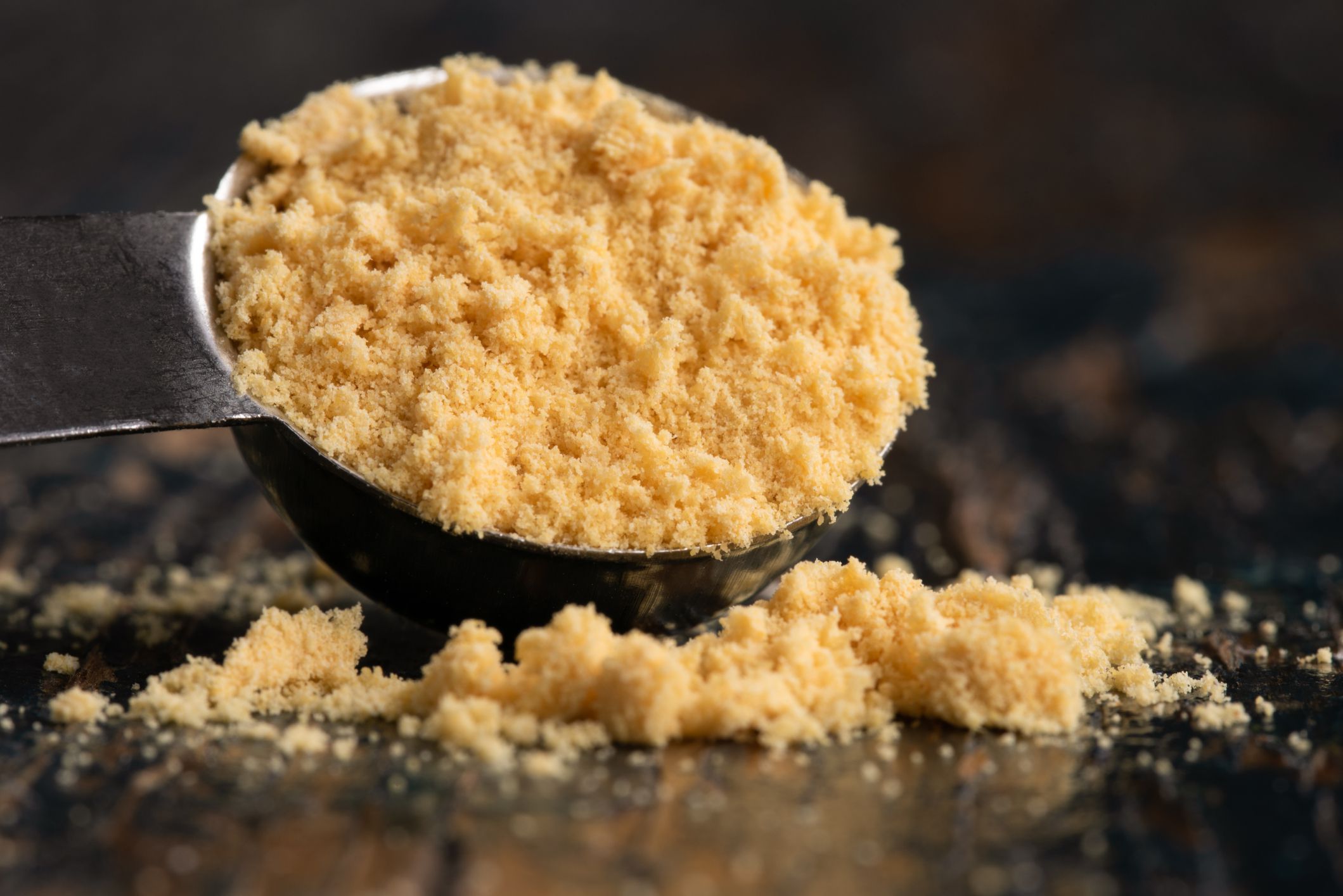 Ground Yellow Mustard Spilled from a Teaspoon