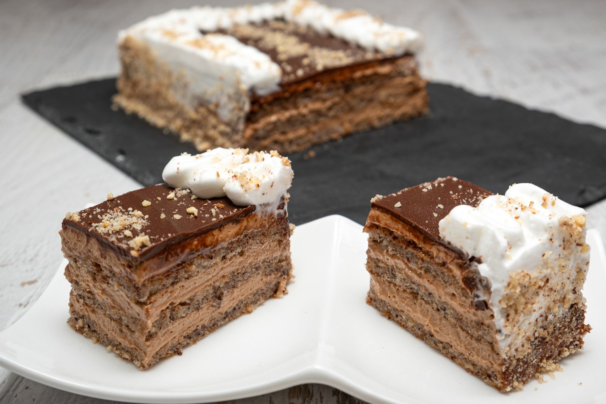 Pieces of delicious caramel cake on table