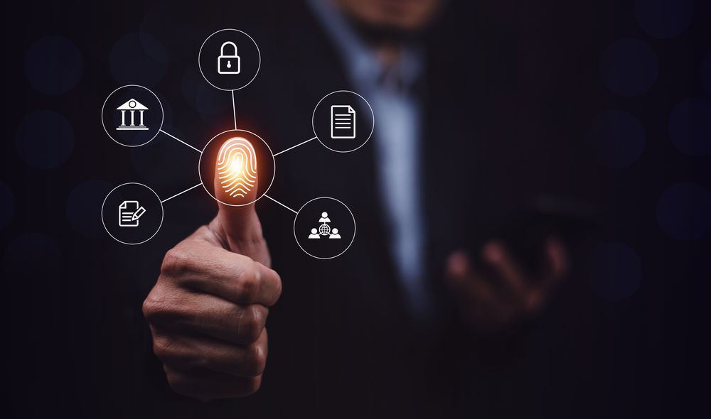 Businessman scans fingerprint to unlock security system Internet storage and financial systems Banking and personal information