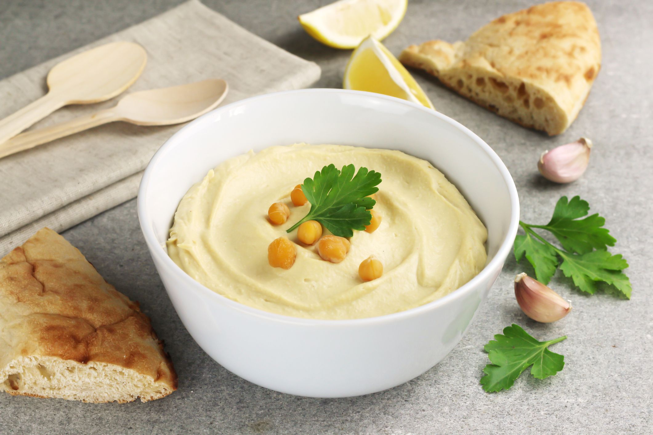 Hummus traditional oriental vegan sauce from chickpea on grey background. Healthy food. Selective focus