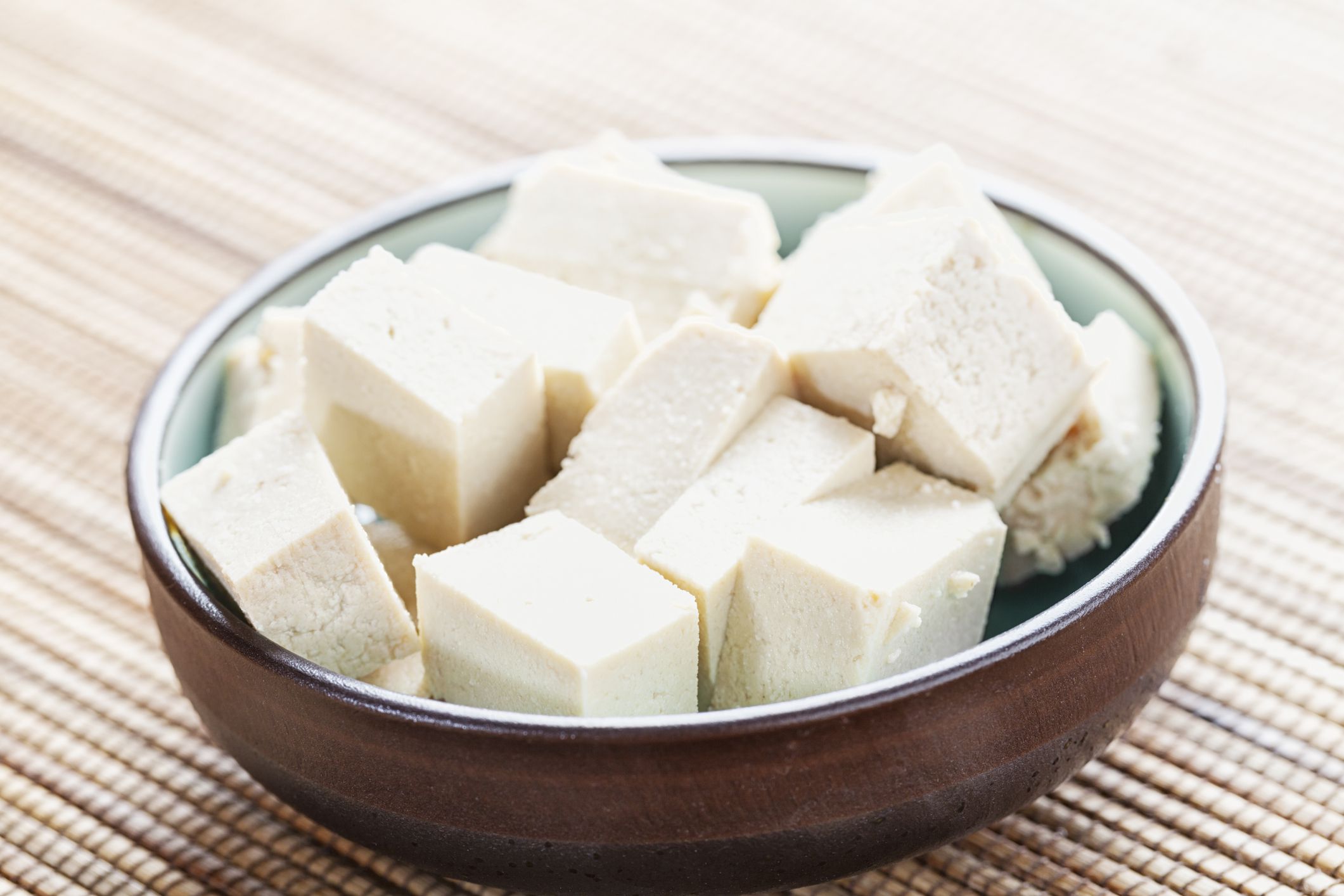 cubes of Tofu, marinating in a small bowl, asian style