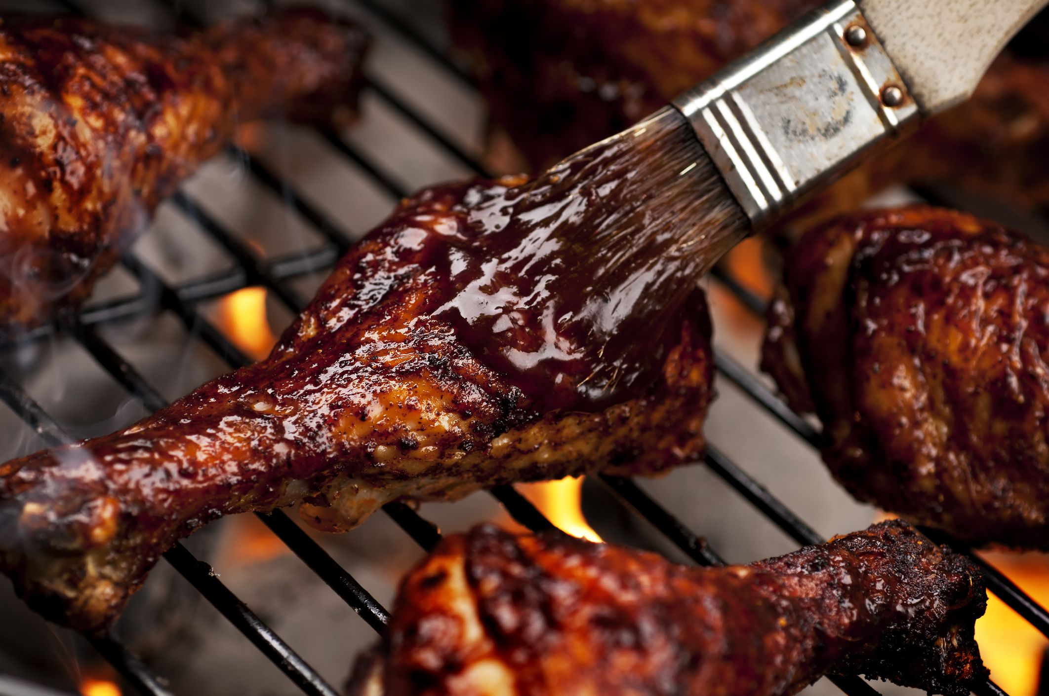 Chicken legs on the grill with barbecue sauce. Please see my portfolio for other food related images.