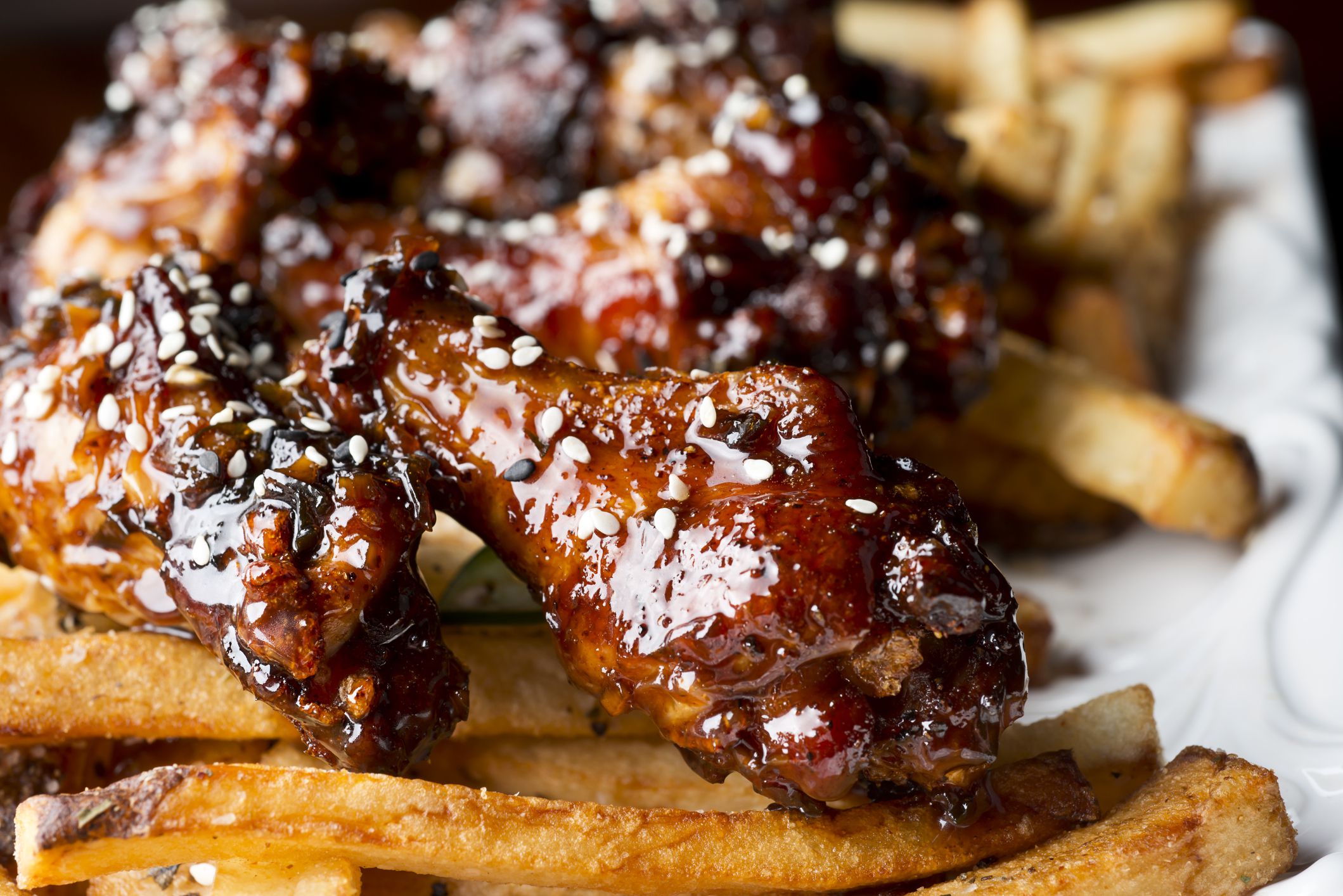 Teriyaki Glazed Chicken Wing Appetizer over French Fries.