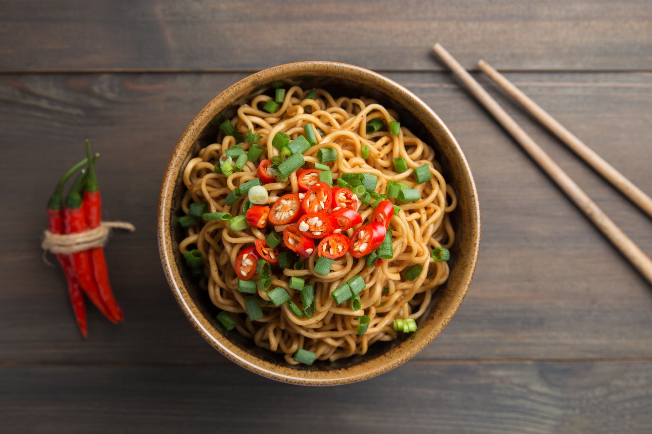 Instant noodles in white black on wood background