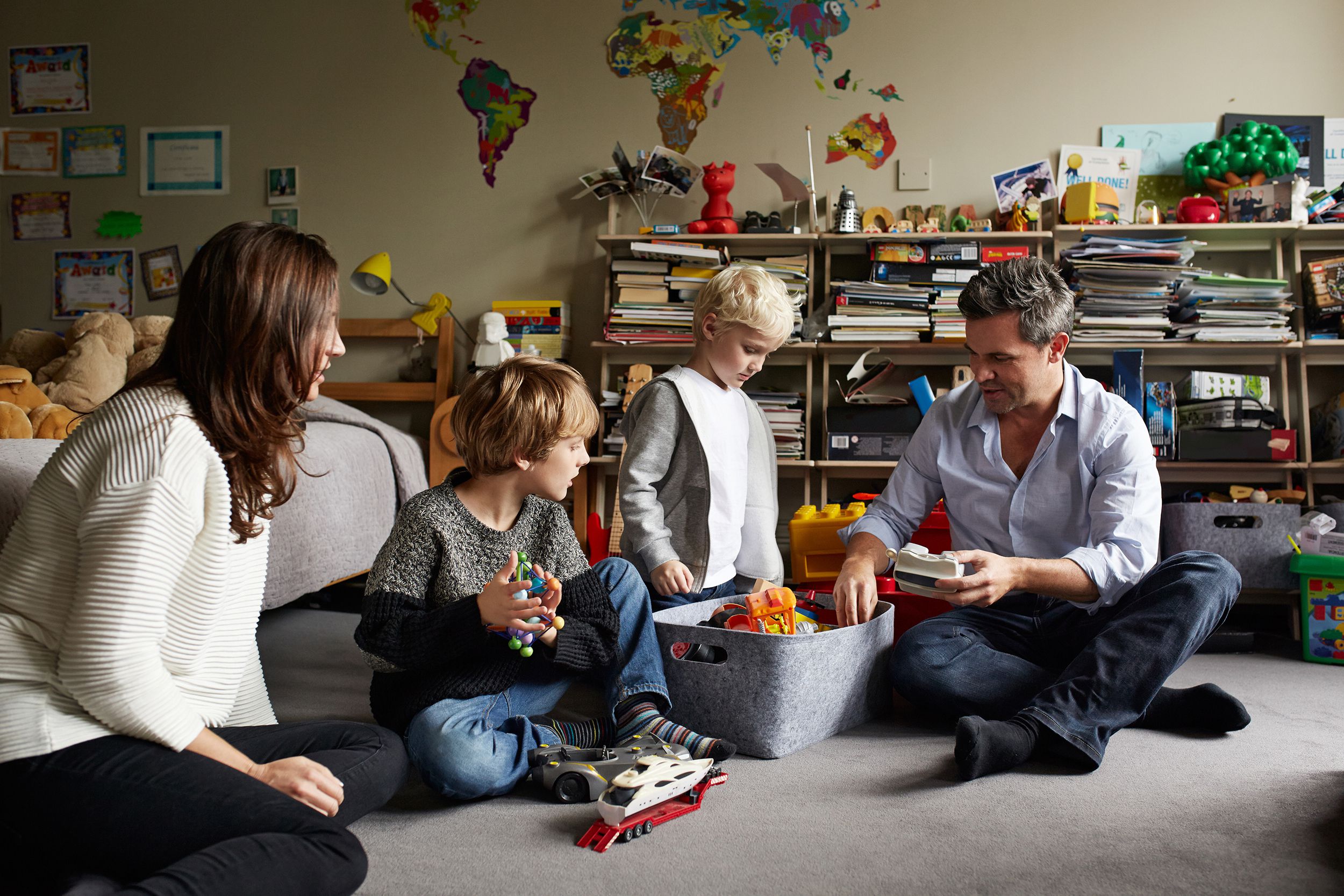 family looking through two sons' toys