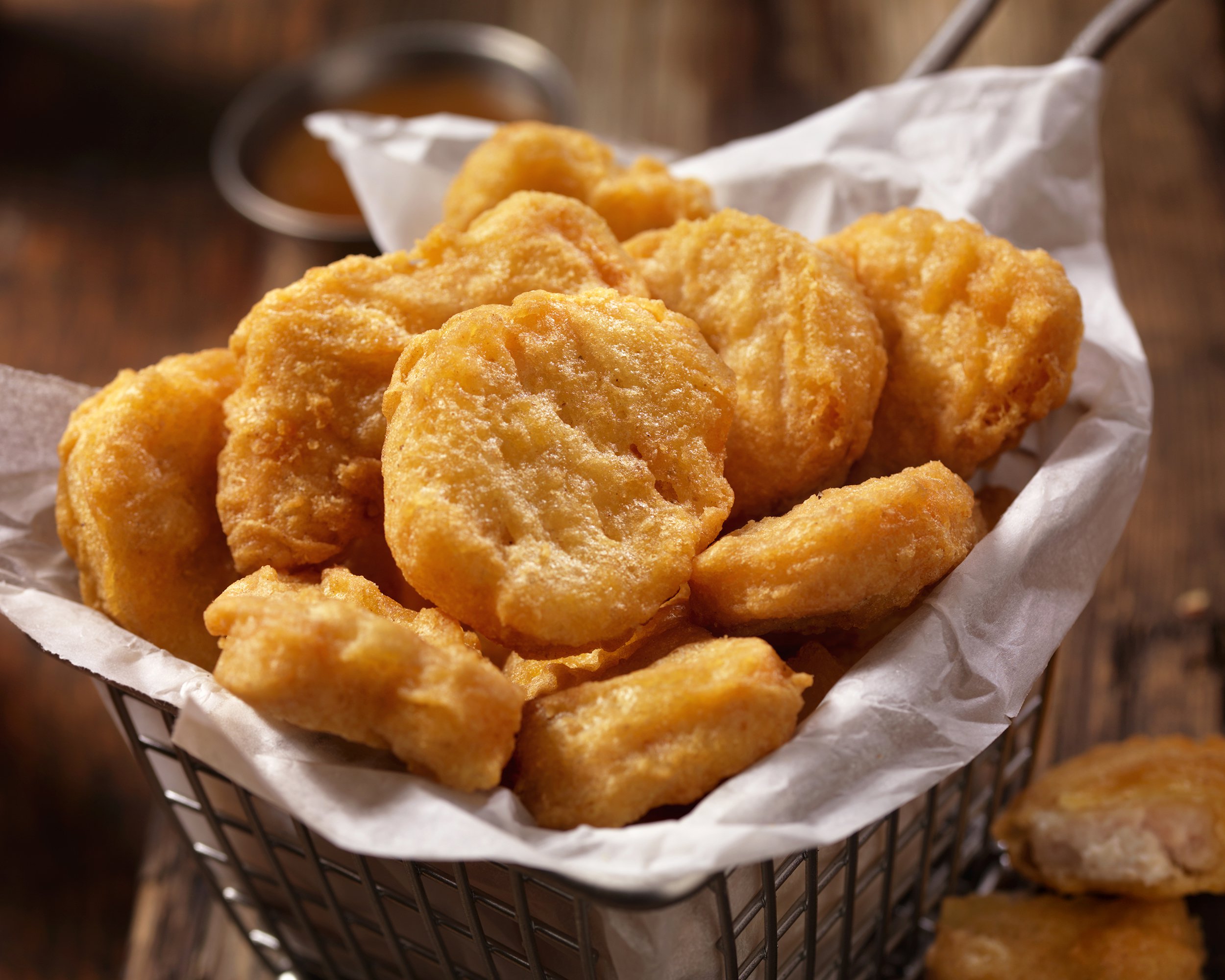 basket of chicken nuggets with sweet and sour sauce