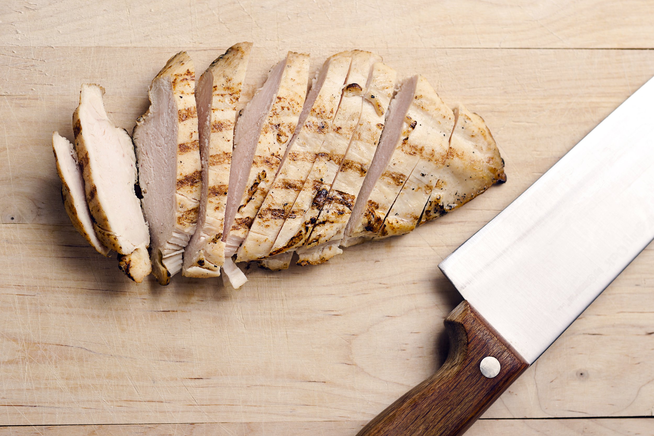 grilled chicken breast slices on wood