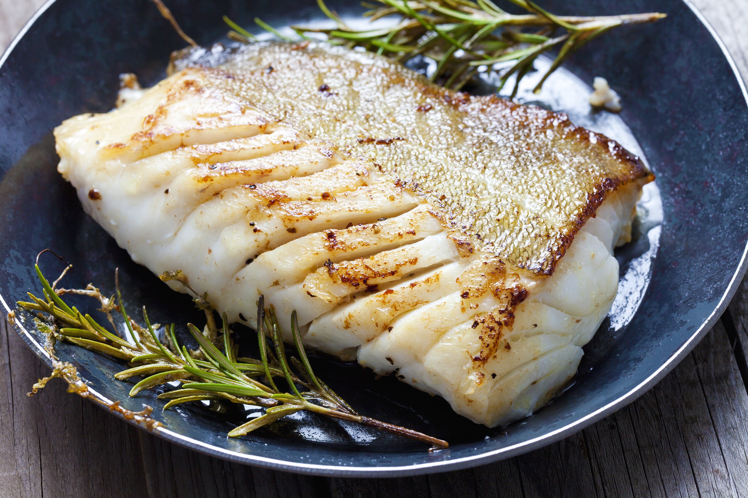 cod fillet with rosemary on a plate