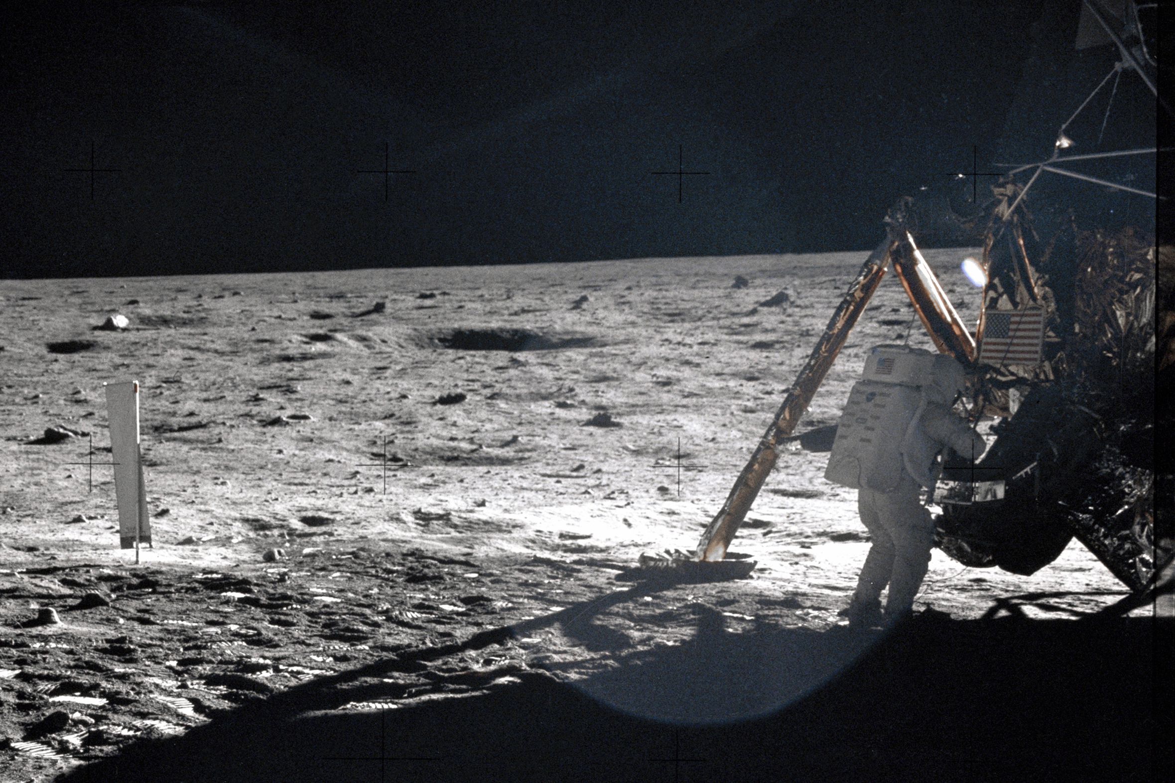 Apollo 11 Commander Neil Armstrong working at an equipment storage area on the lunar module, on the moon, July 20, 1969