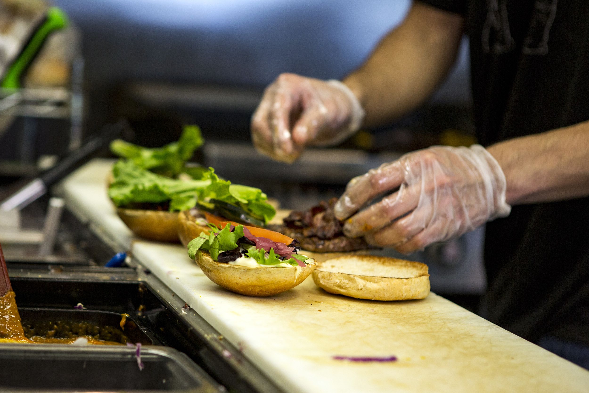 Preparing burgers in a restaurant kitchen