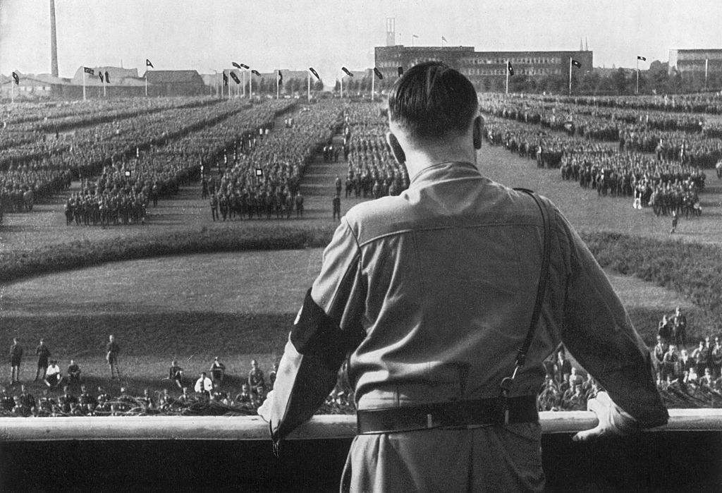 German Fuhrer and Nazi leader Adolf Hitler watches soldiers with his back facing the camera at a Nazi rally in Dortmund, Germany.
