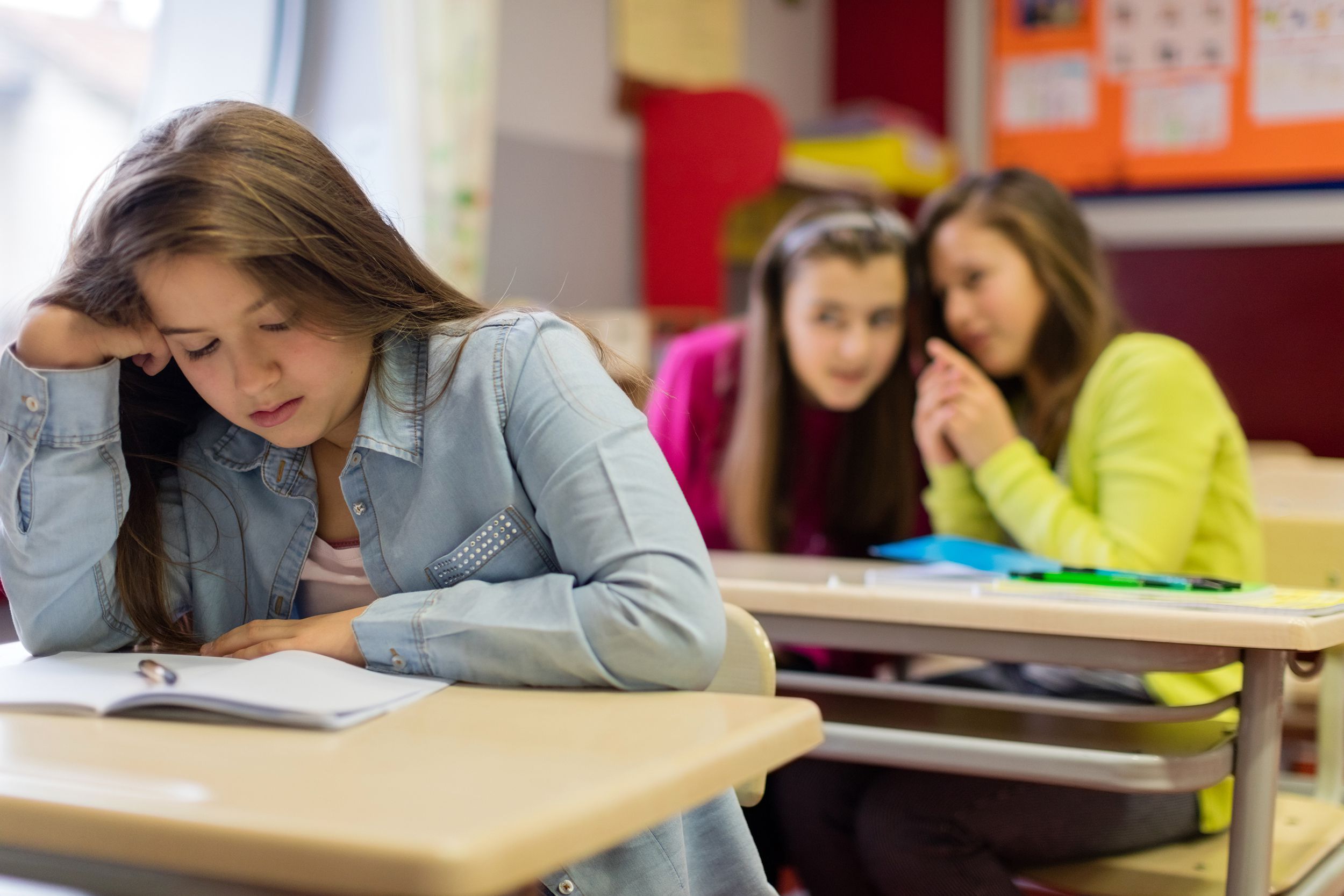 Girl ignoring bullies at school