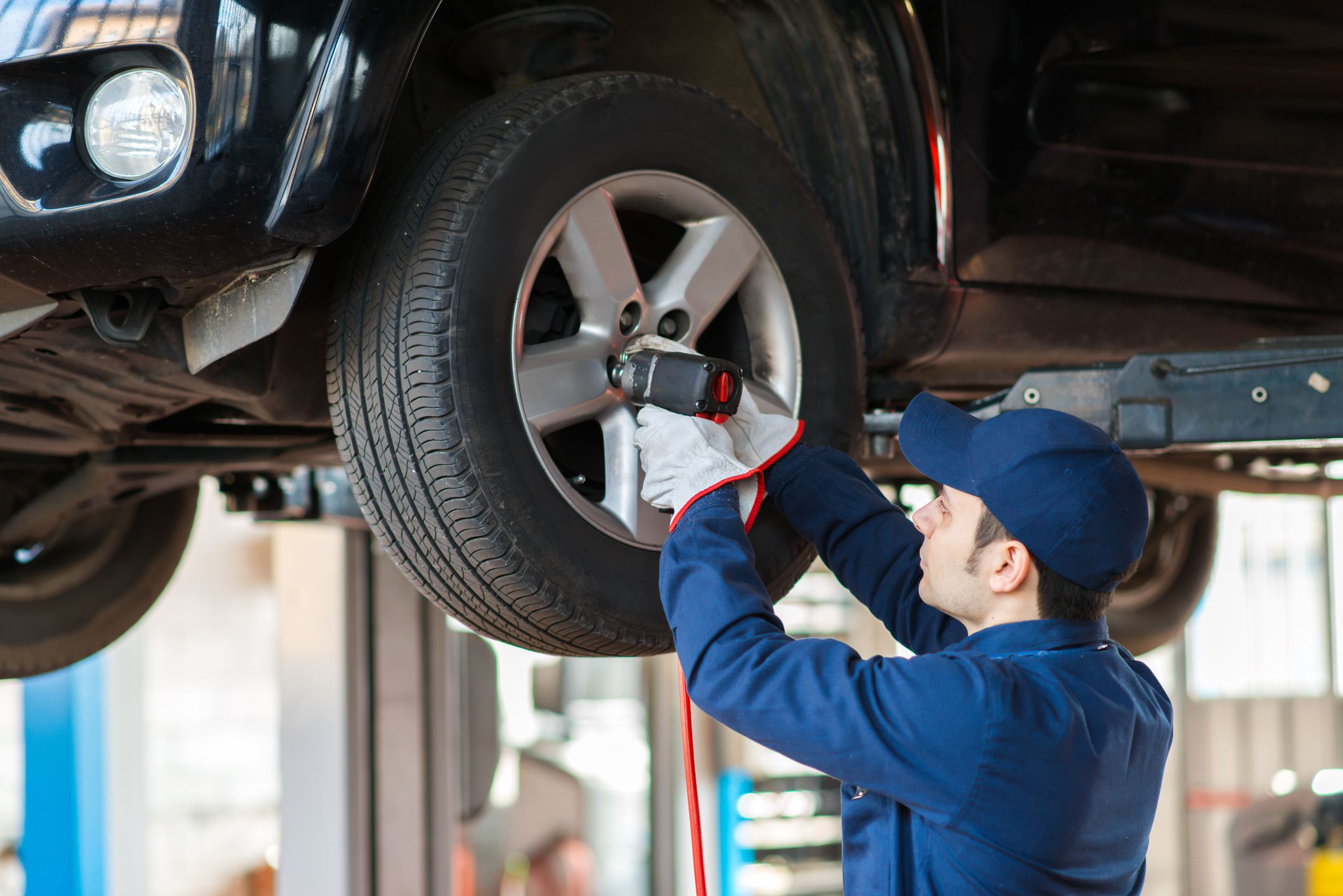 Portrait of a mechanic replacing tire