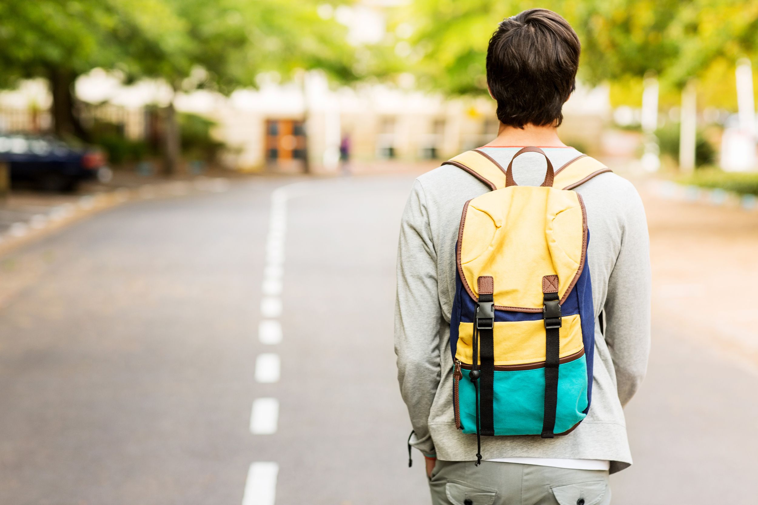 Boy with a backpack walking to school