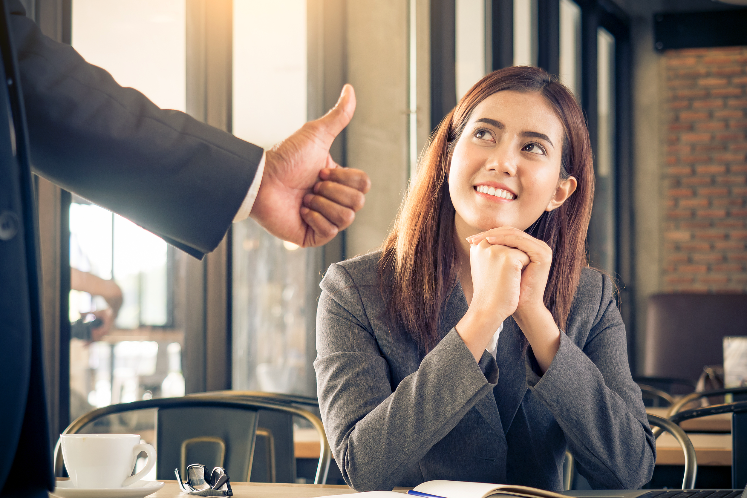 Boss giving employee a thumbs up