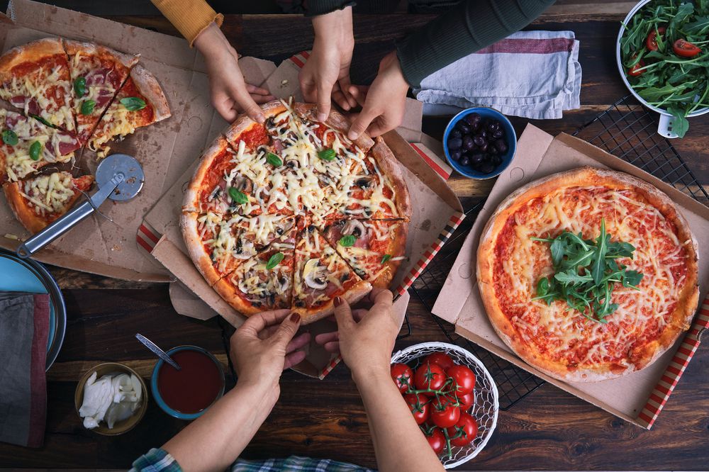 Family Eating Pizza at Home Out of Pizza Box