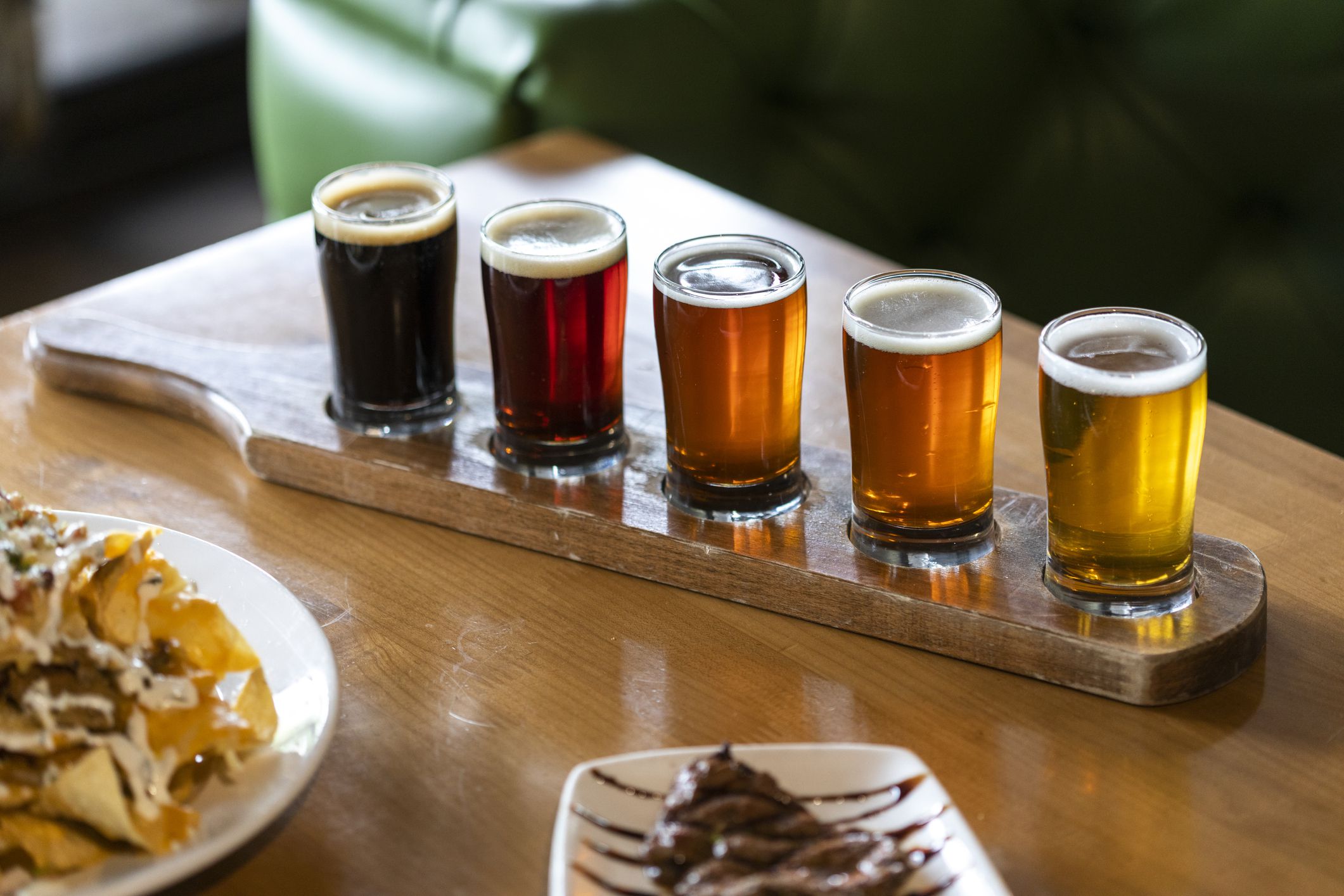 Flight of beers ranging in color from light to dark on wood carrier. in Chandler, AZ, United States