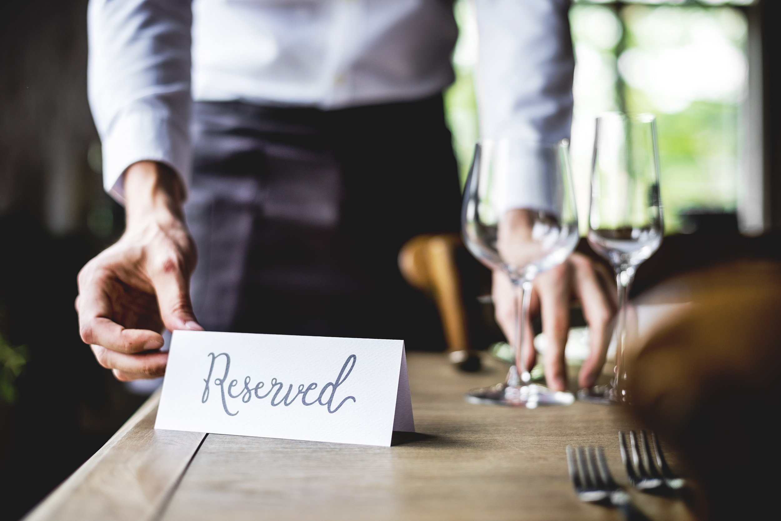 elegant restaurant table setting service for reception with reserved card