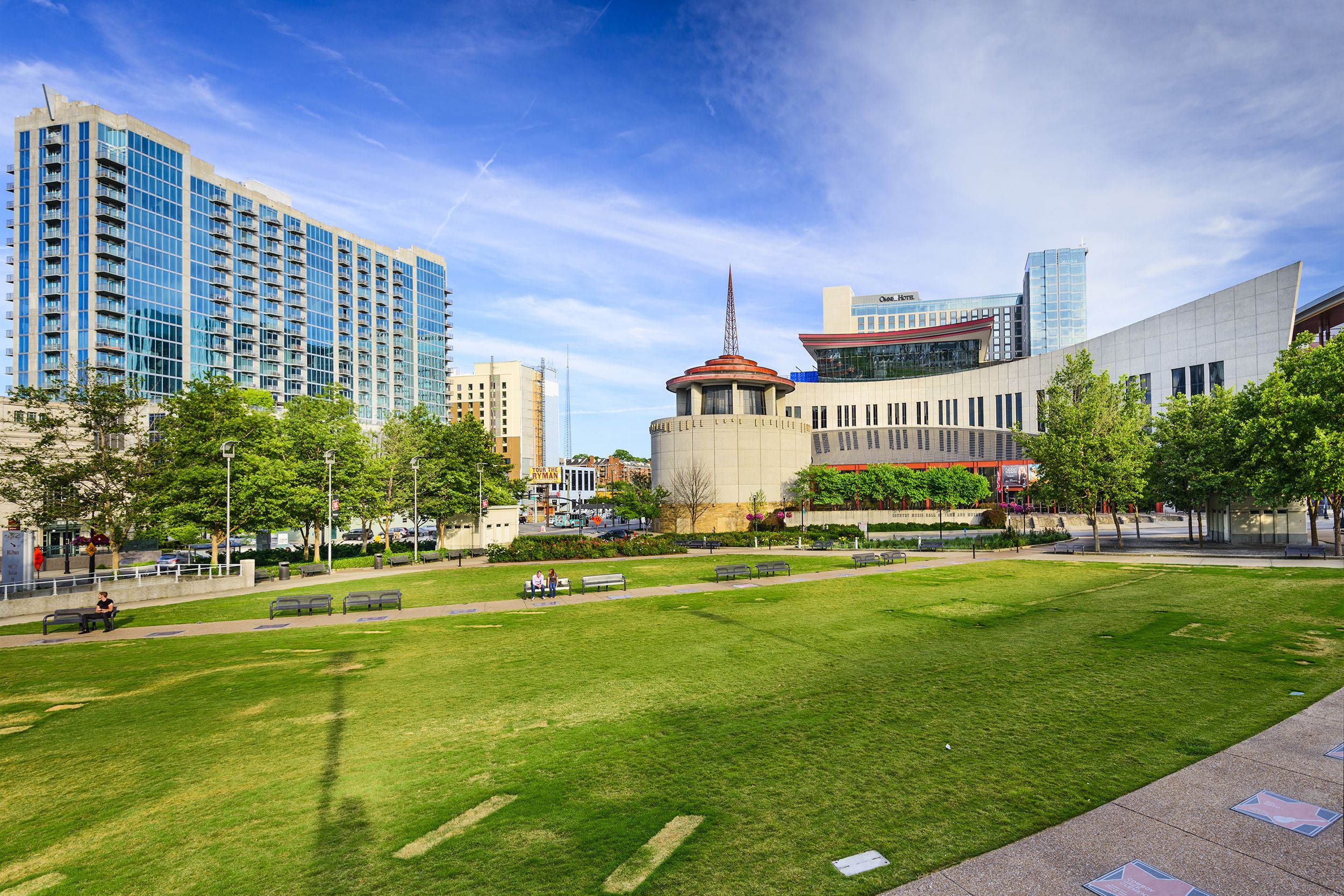 Country Music Hall of Fame and Museum, Nashville, walkway and garden in the foreground, on a sunny day in spring with a dramatic blue sky in the background