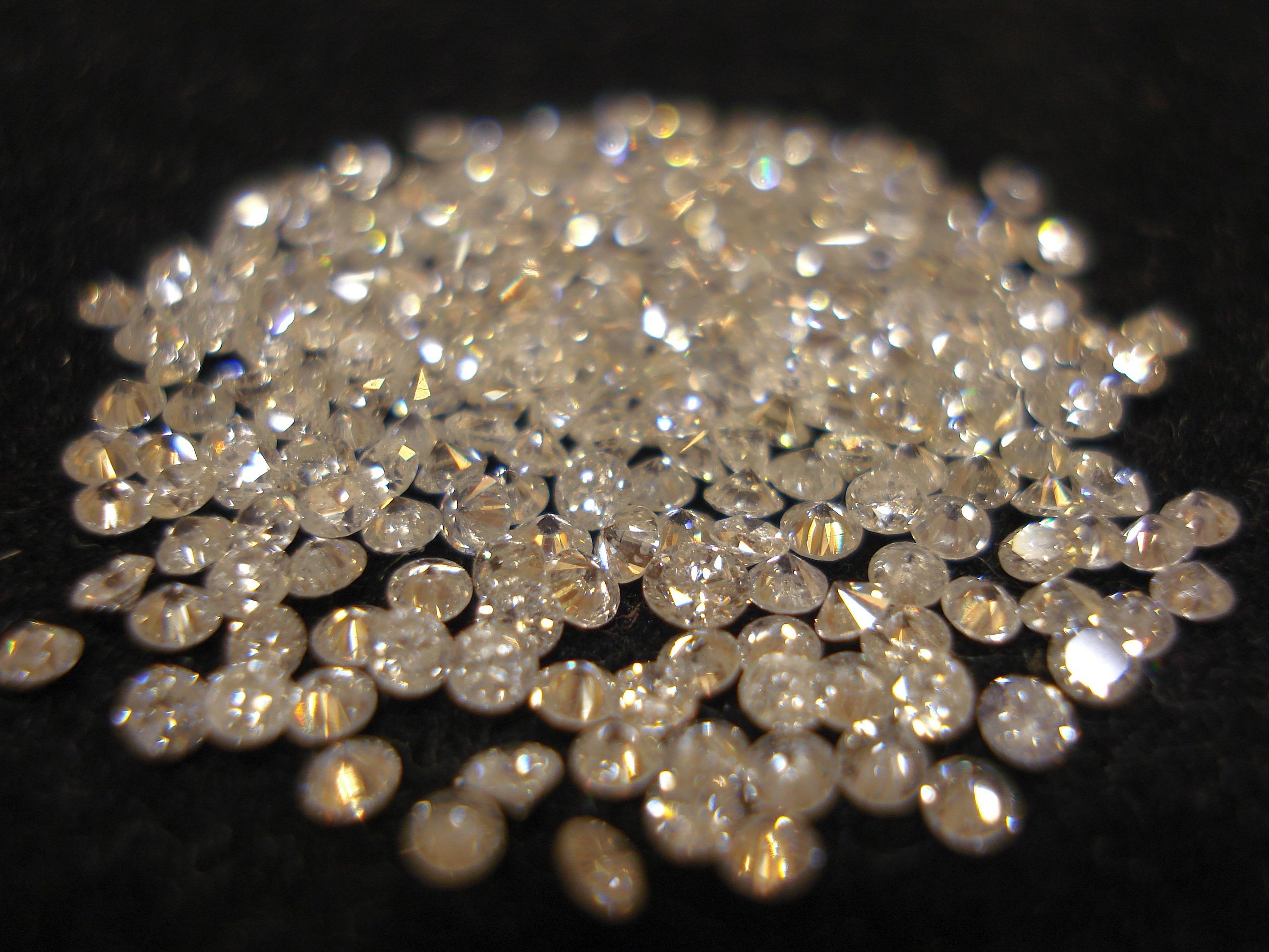 Pile of cut diamonds on a black background