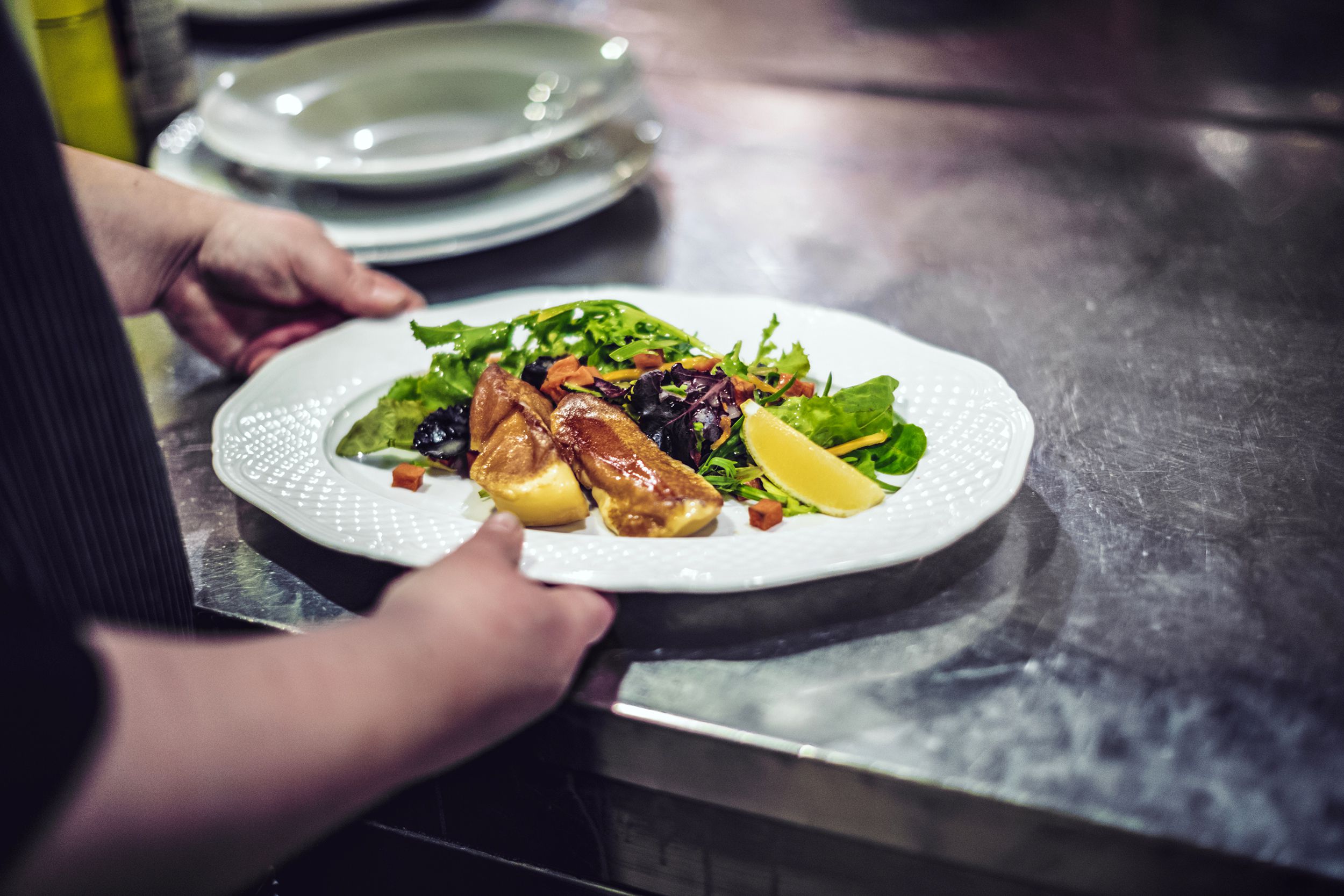 Chef holding plate of food