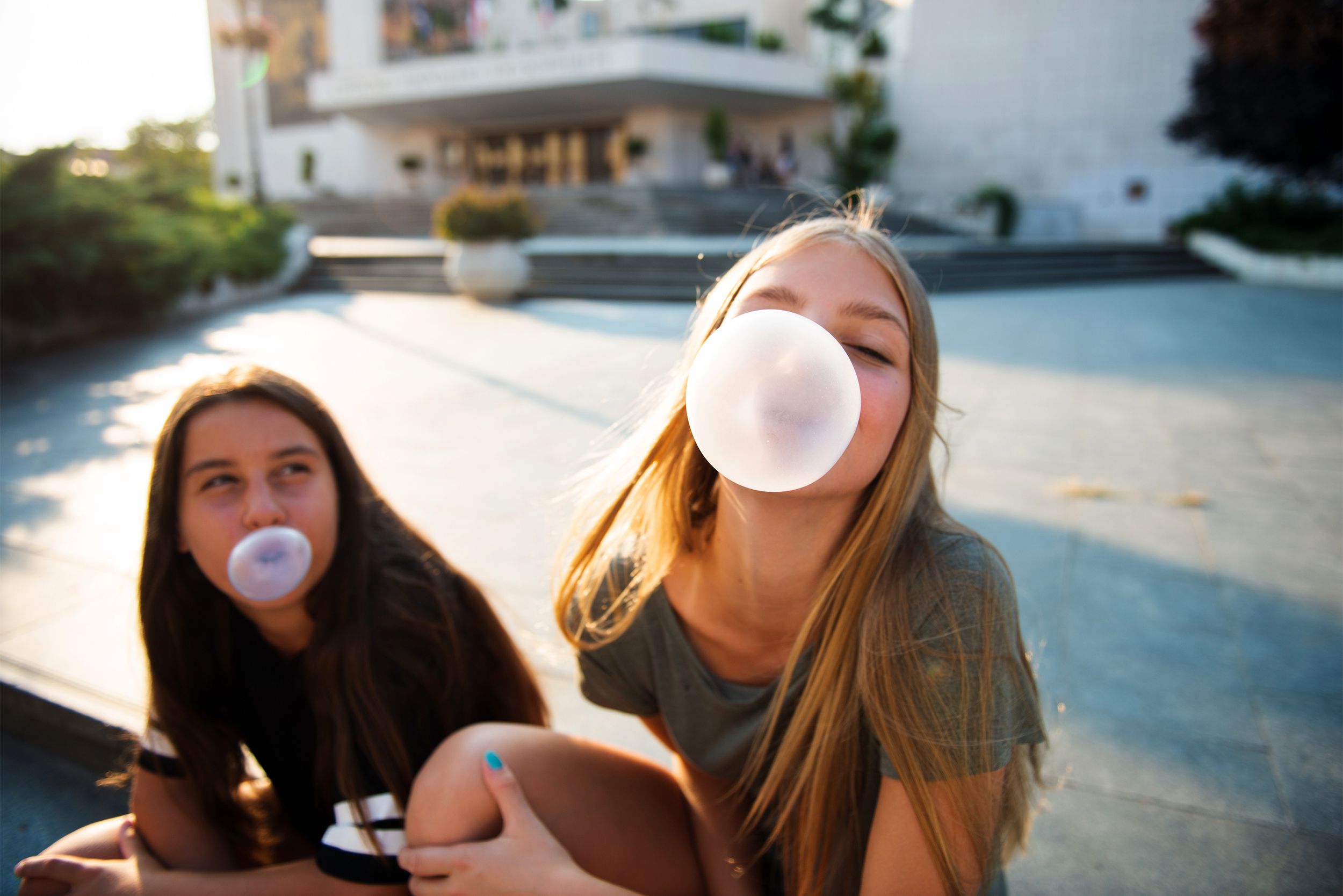 Teenagers chewing gum and blowing bubbles