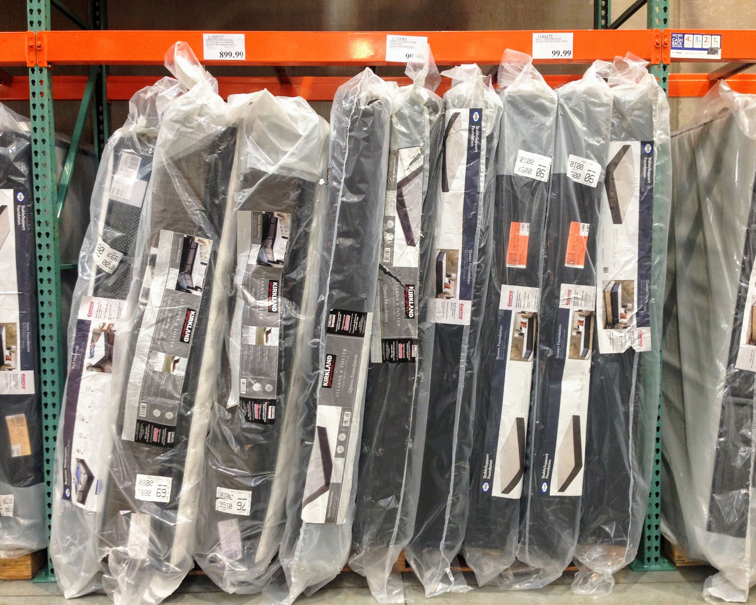 Plastic wrapped mattresses stacked vertically at Costco
