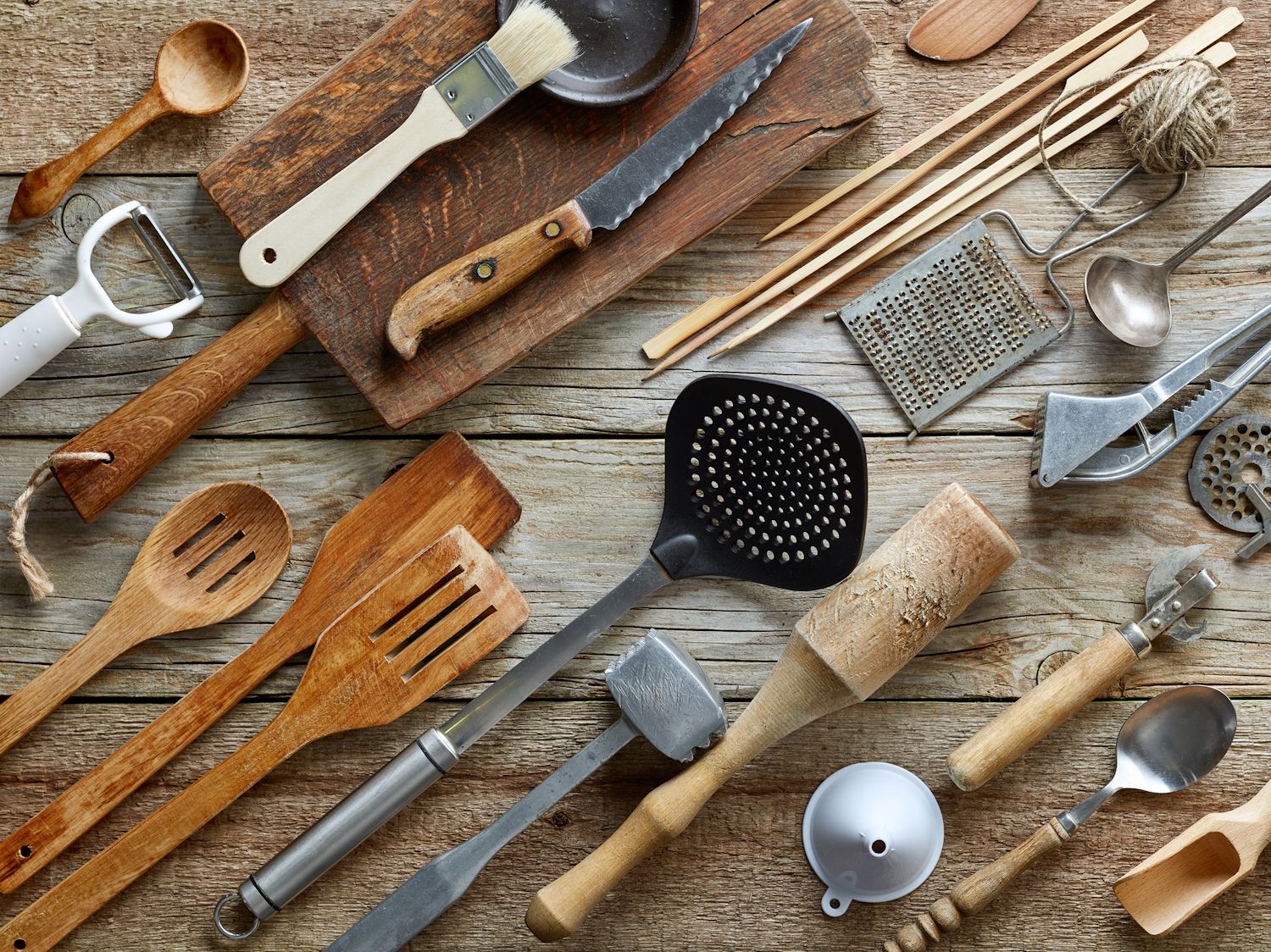 various kitchen utensils on wooden table, top view