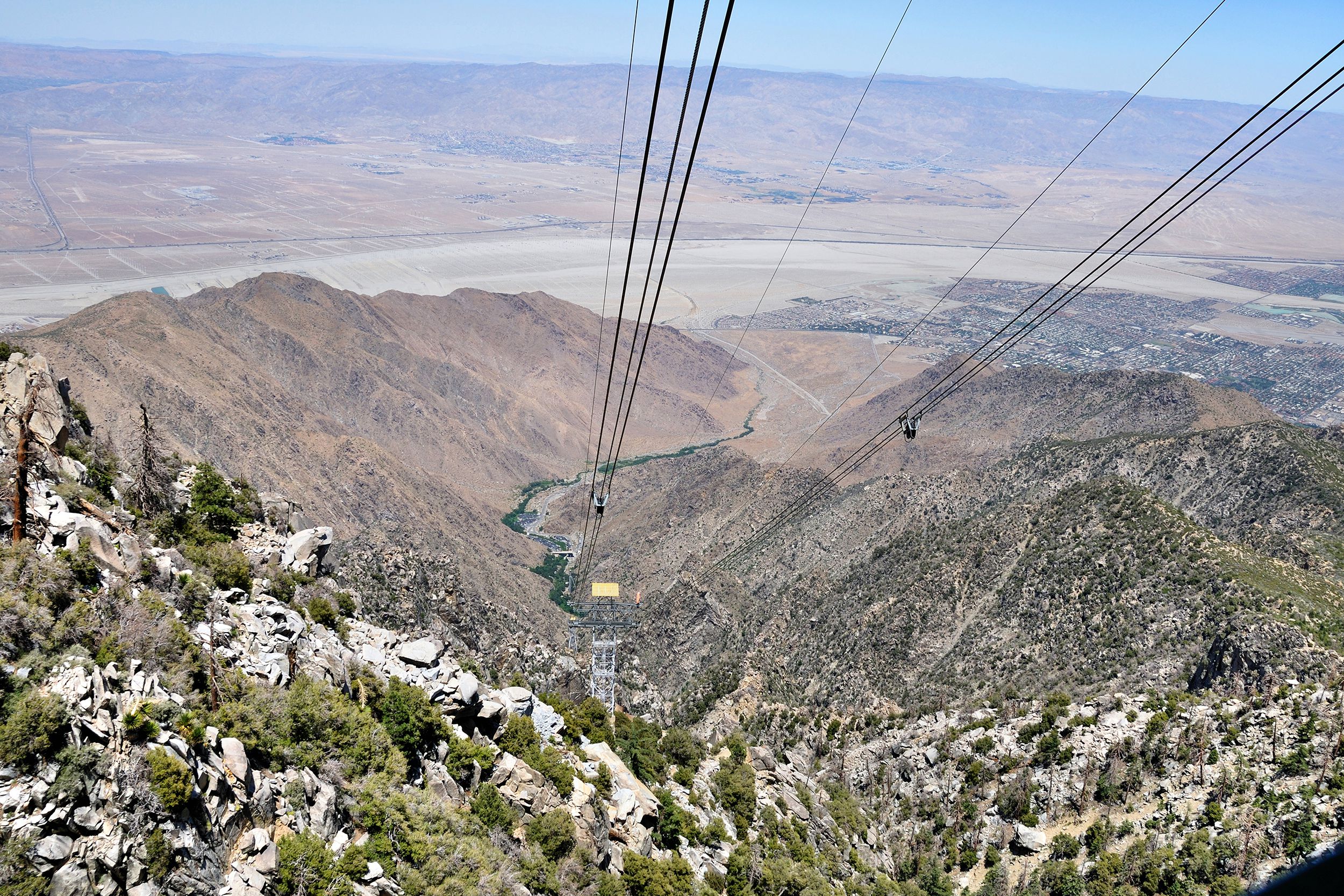 Aerial view of valley looking down from the Palm Springs Aerial Tramway, Palm Springs, California, wide expansive view of mountains in the distance on a sunny day