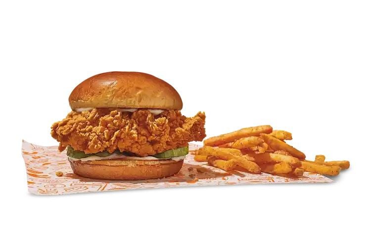 Popeyes chicken sandwich with fries.