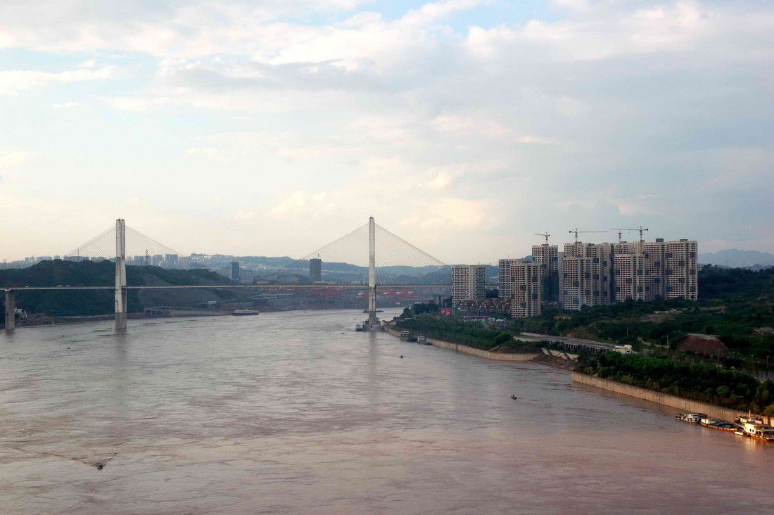 Dafosi Yangtze River Bridge in Chongqing city, China on an overcast day at dusk.
