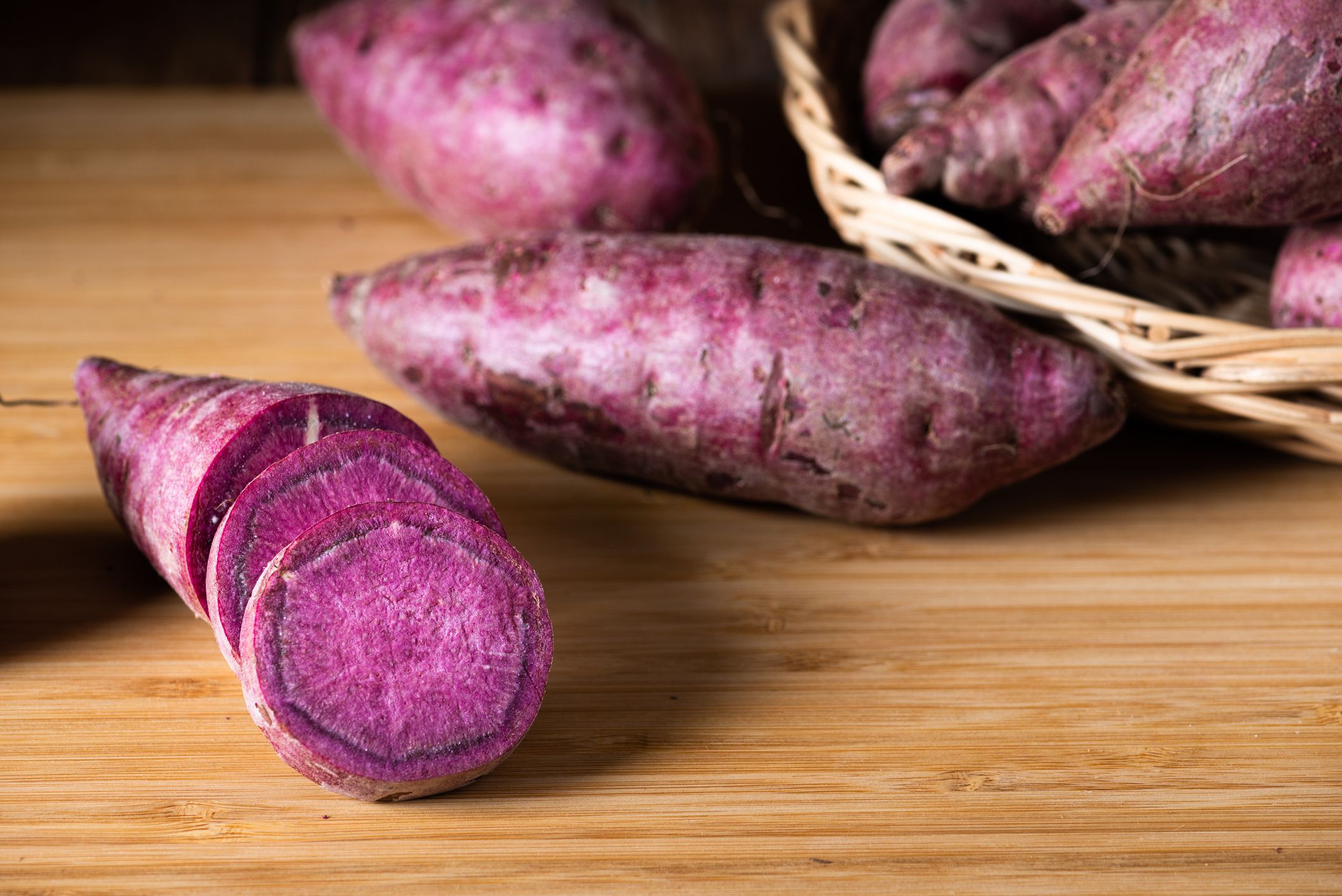 Sweet Potatoes Purple Colored on Wood Table background