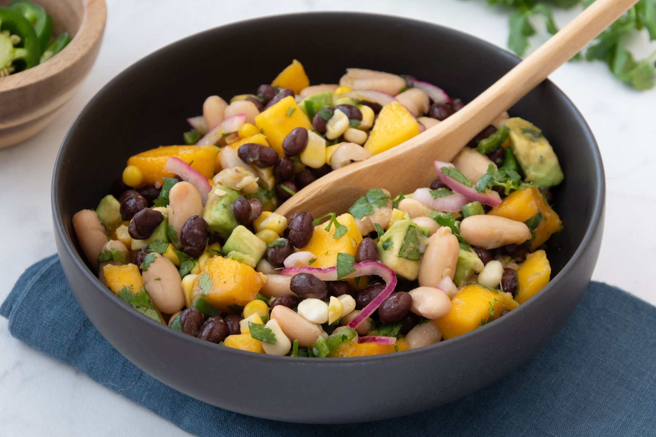 Festive mango black and white bean avocado salad (or salsa) with corn, red onions, cilantro and jalapeno