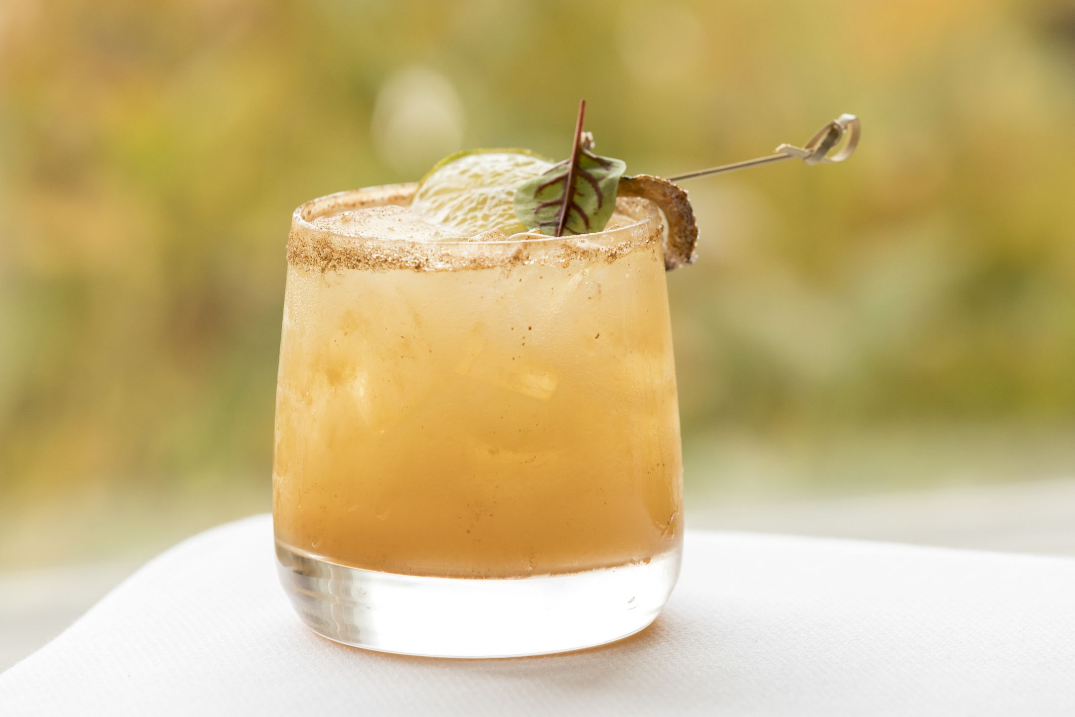 Colorful pumpkin fall-inspired cocktail with fall colors in background in Chatham, MA, United States