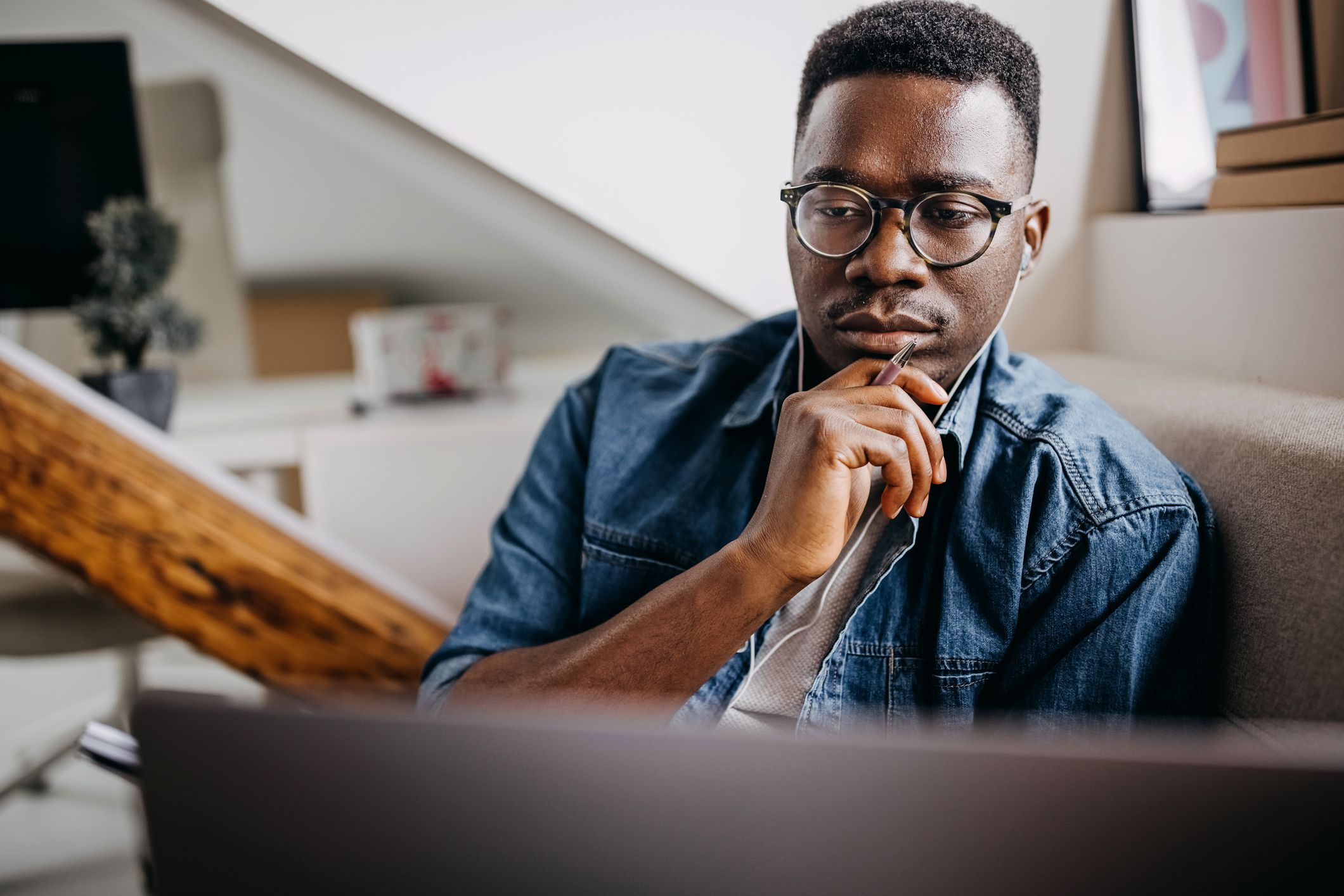 Shot of a young working from the comfort of his home