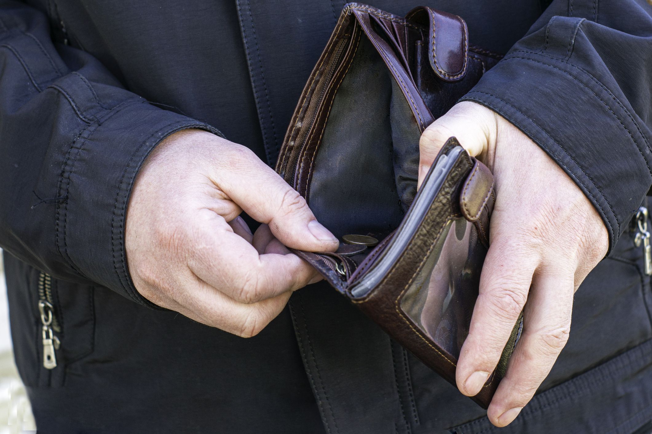 concept economic crisis poverty man will open a wallet in which there are only a few coins